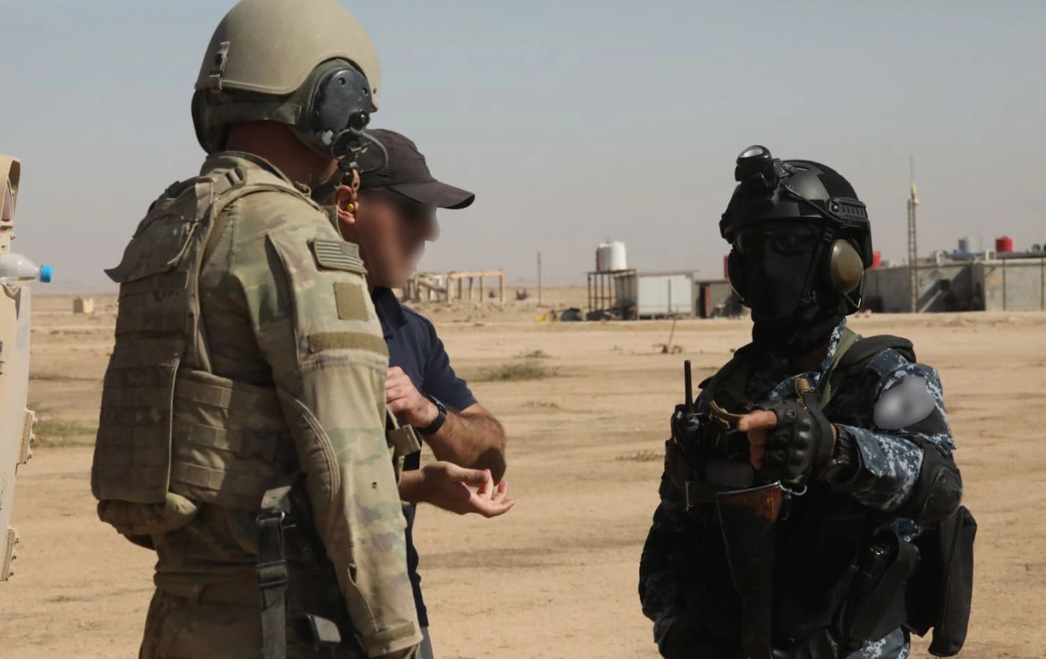 An-anti ISIS Coalition soldier and an Asayish member discuss the Bradley Fighting Vehicle during a range in Rojava’s Hasaka province. Date: September 29, 2021. Photo: Coalition 