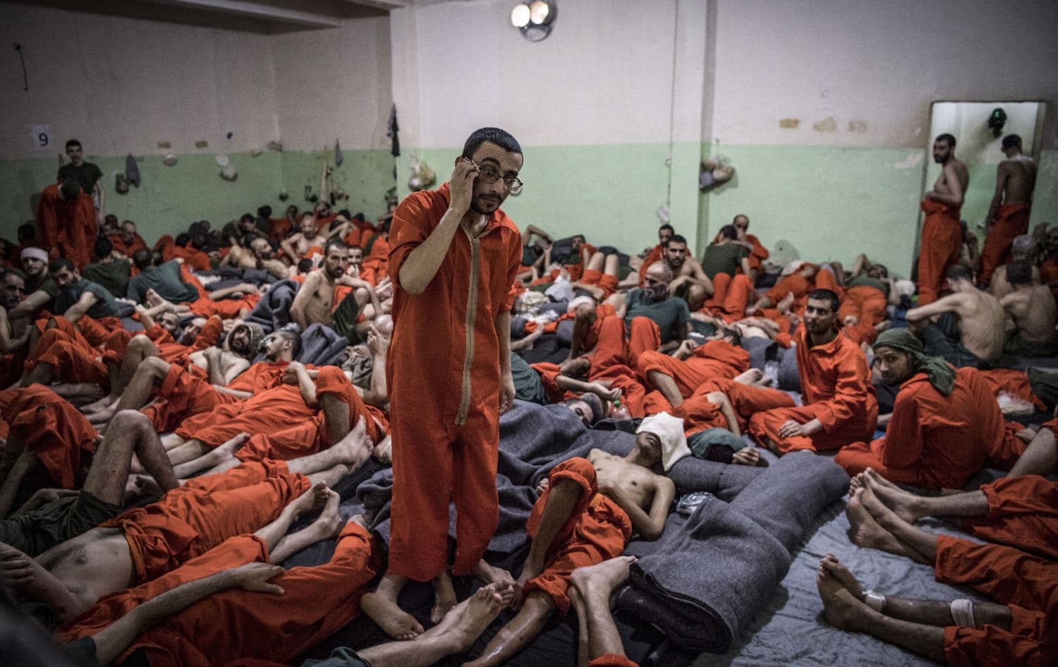 Men suspected of being affiliated with the Islamic State (ISIS), gathered in a cell of al-Sina'a prison in Hasaka's Ghweran neighborhood on October 26, 2019. File Photo: Fadel Senna/AFP