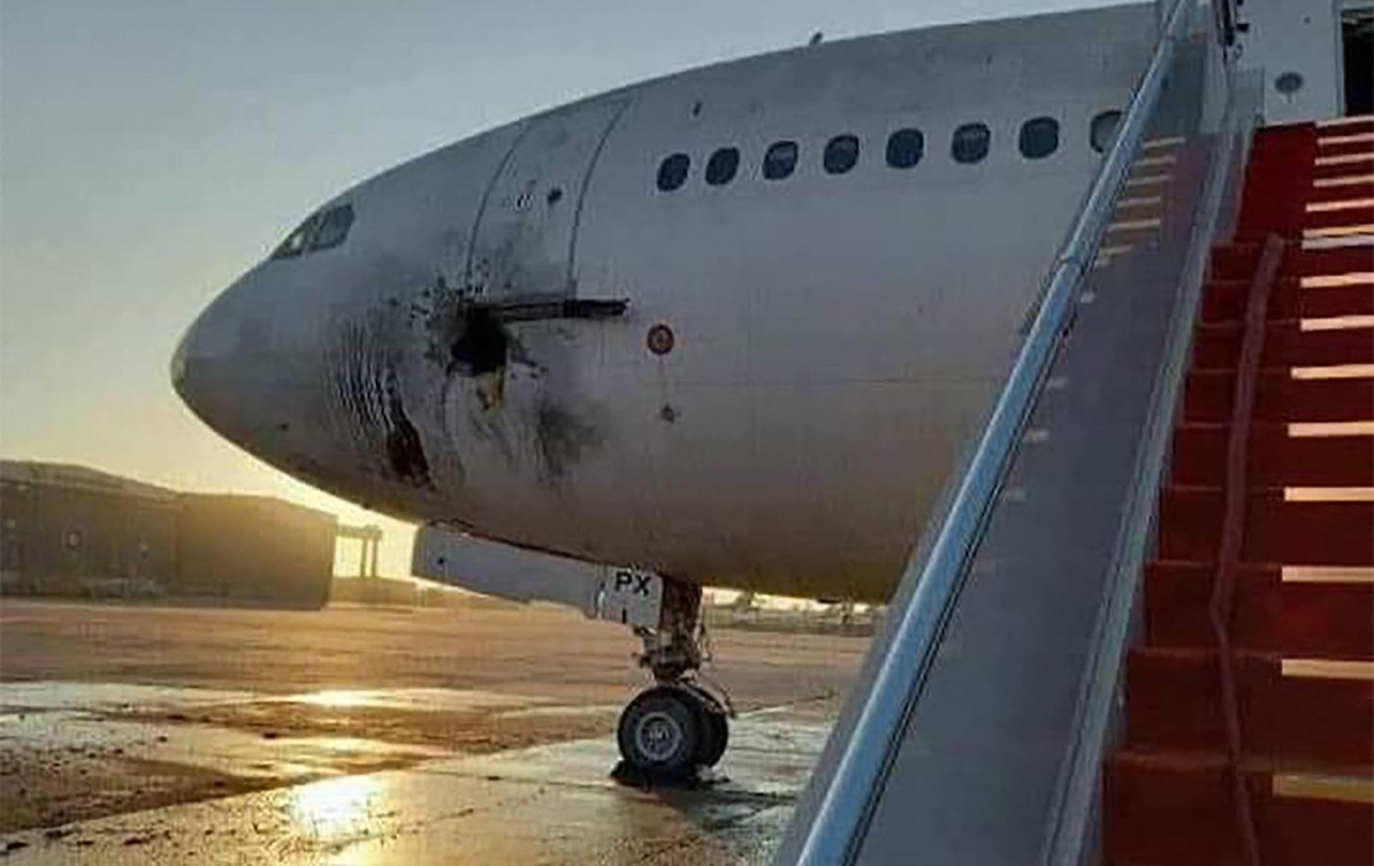 A handout picture shows a damaged stationary aircraft on the tarmac of Baghdad airport, after rockets reportedly tragetted the runway, on January 28. Photo:  Facebook page of Iraqi Ministry of Transportation 