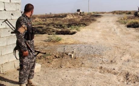 AFP file photo of a fighter from Amerli guarding a road to the town.
