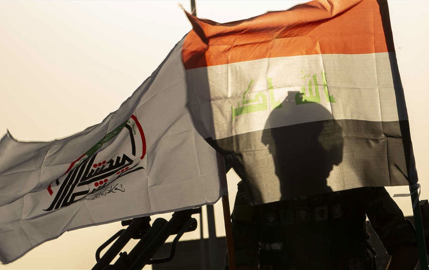 PMF members take part in a military parade in Basra on June 14, 2020. PhotoL Hussein Faleh/AFP