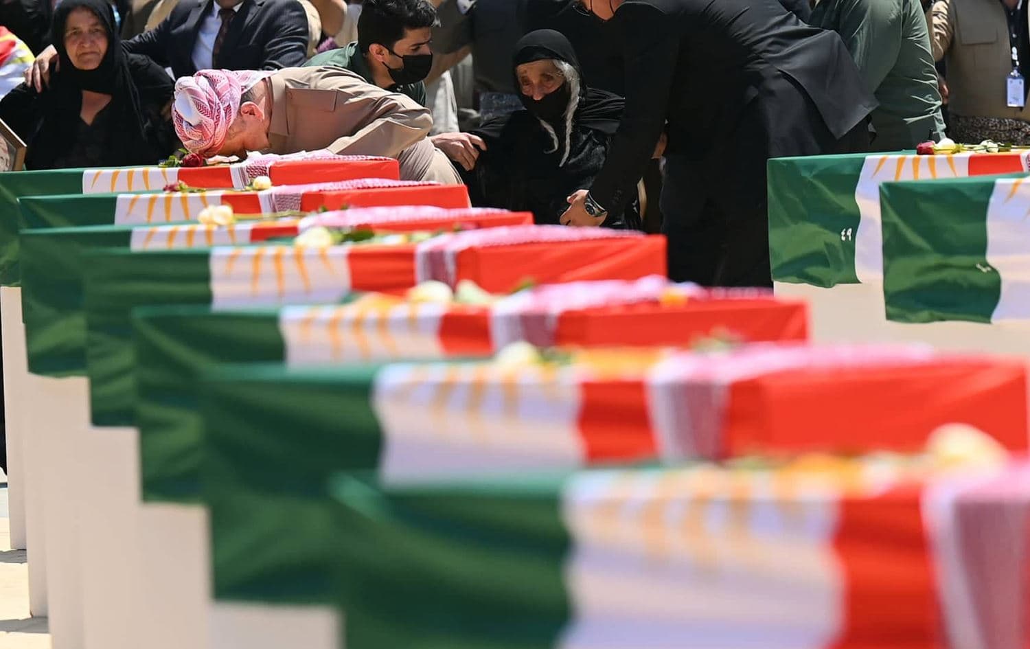 Kurdistan Democratic Party Leader Masoud Barzani mourns over a coffin draped with the Kurdish flag and containing the remnants of a victim of Barzan genocide on July 31, 2022. Photo: Bilind T. Abdullah/Rudaw