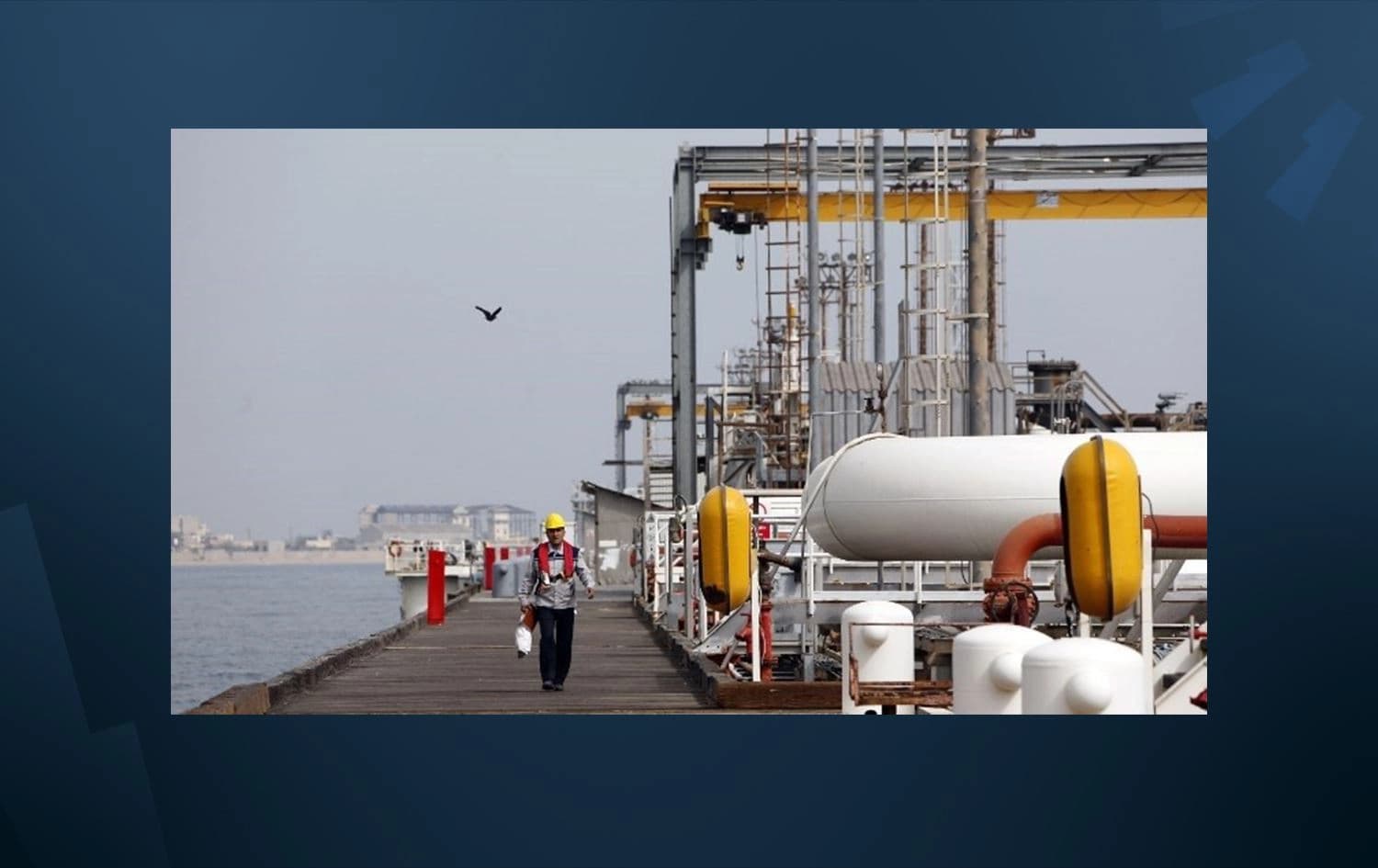 This photo from March 12, 2017, shows an Iranian laborer walking the platform of the oil facility in the Khark Island, on the shore of the Gulf. Photo: Atta Kenare/AFP