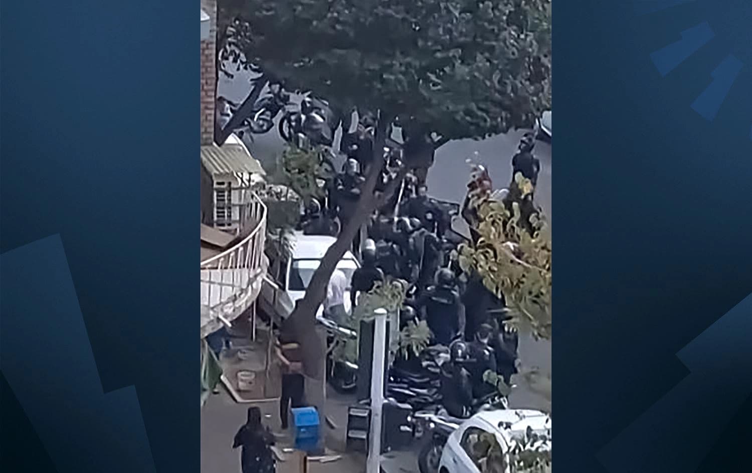 This image grab from a UGC video made available on Twitter reportedly on October 24, 2022 shows Iranian security forces gathering outside the Shahid Sadr Girls high school in Tehran. Photo: UGC/AFP