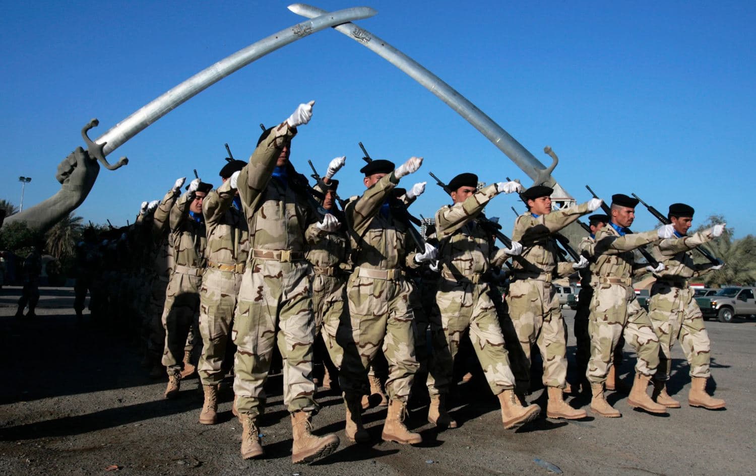 A file picture shows Iraqi soldiers practicing ahead of the Army Day parade at the “Victory Arch”, in Baghdad's Green Zone, Iraq. Photo: AFP
