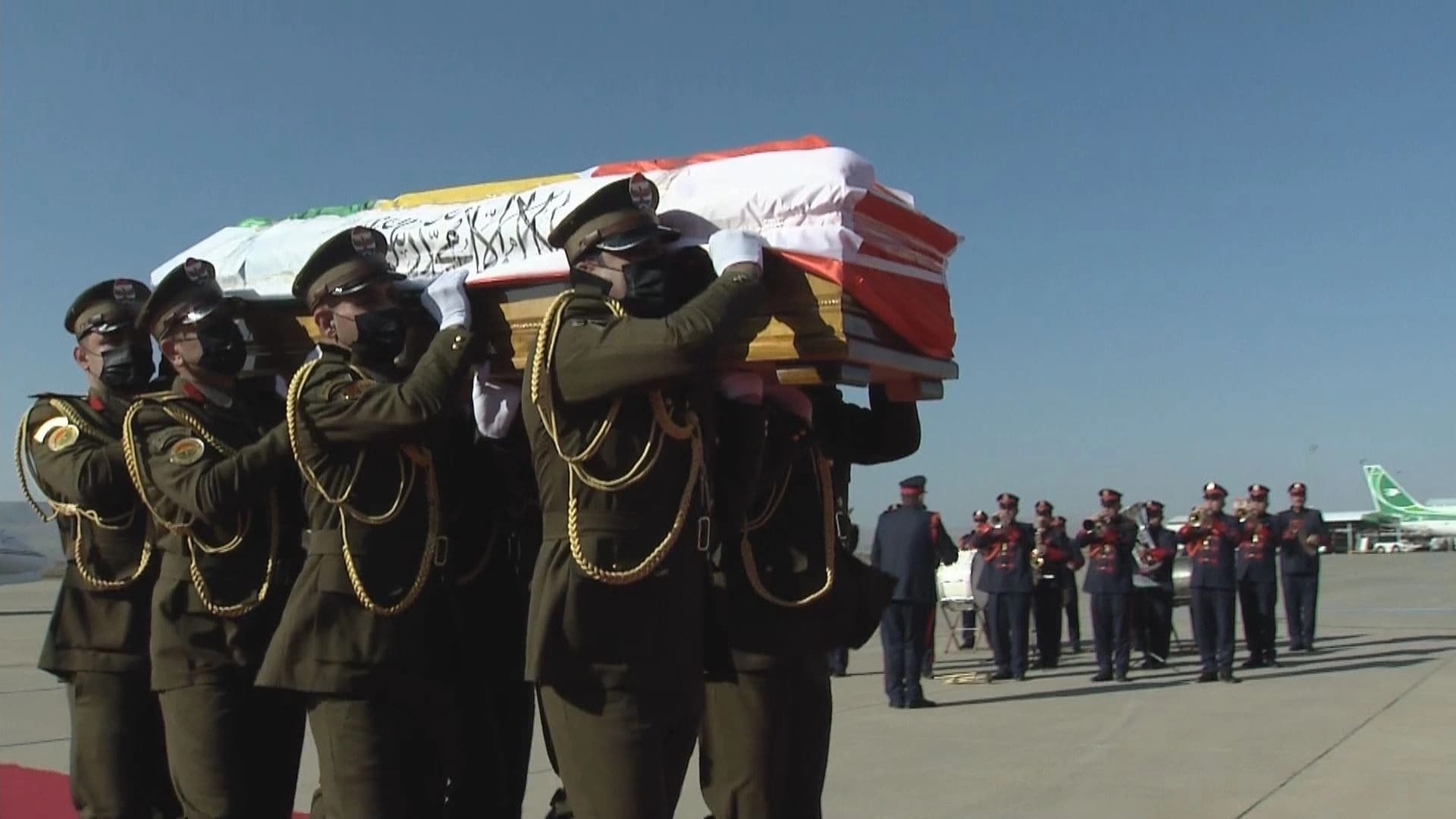 Peshmerga officers carry the dead body of Akam Omar at the Sulaimani International Airport on December 17, 2022. Photo: Rudaw