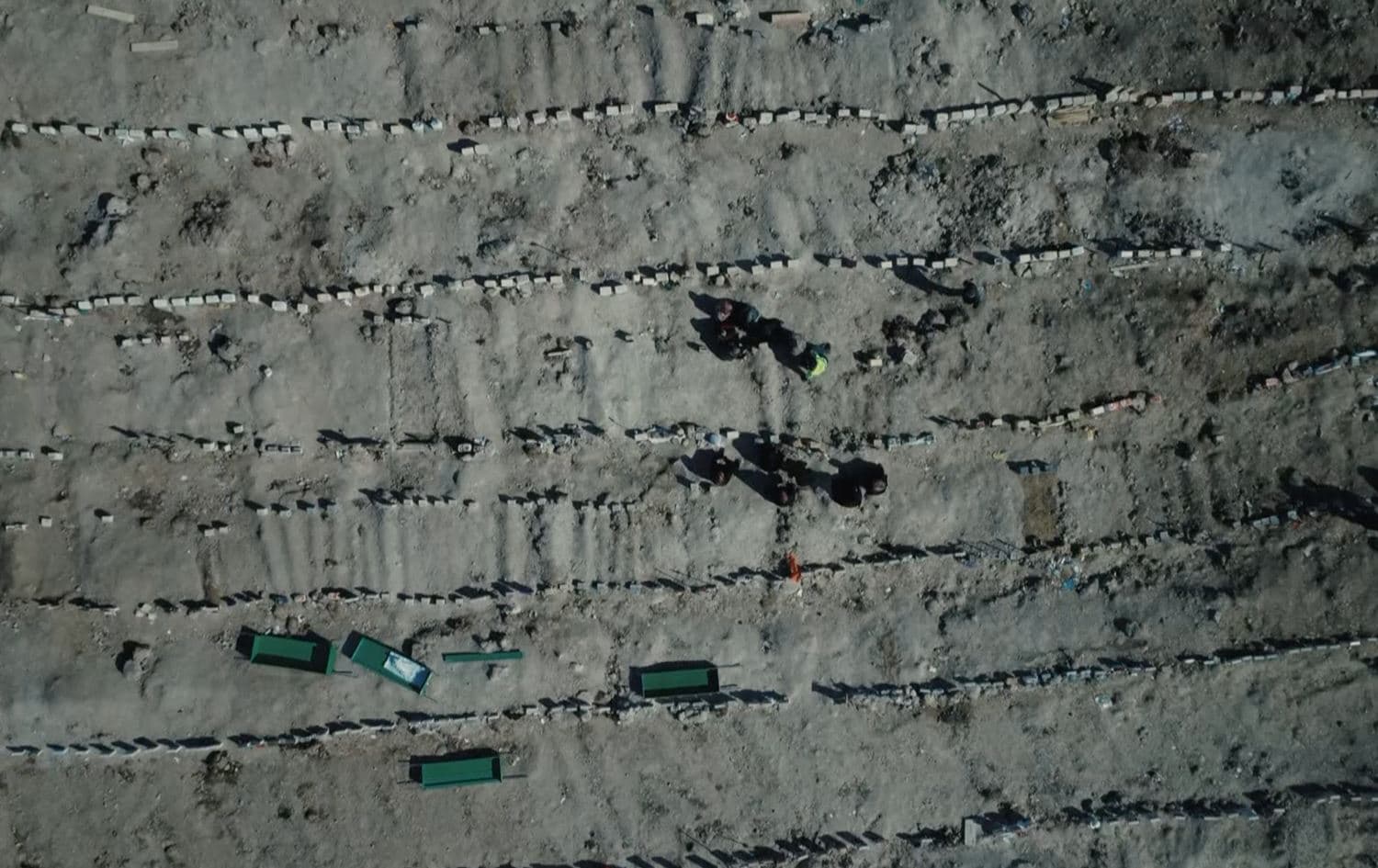 Earthquake destruction leaves mourning families burying dead in mass graves