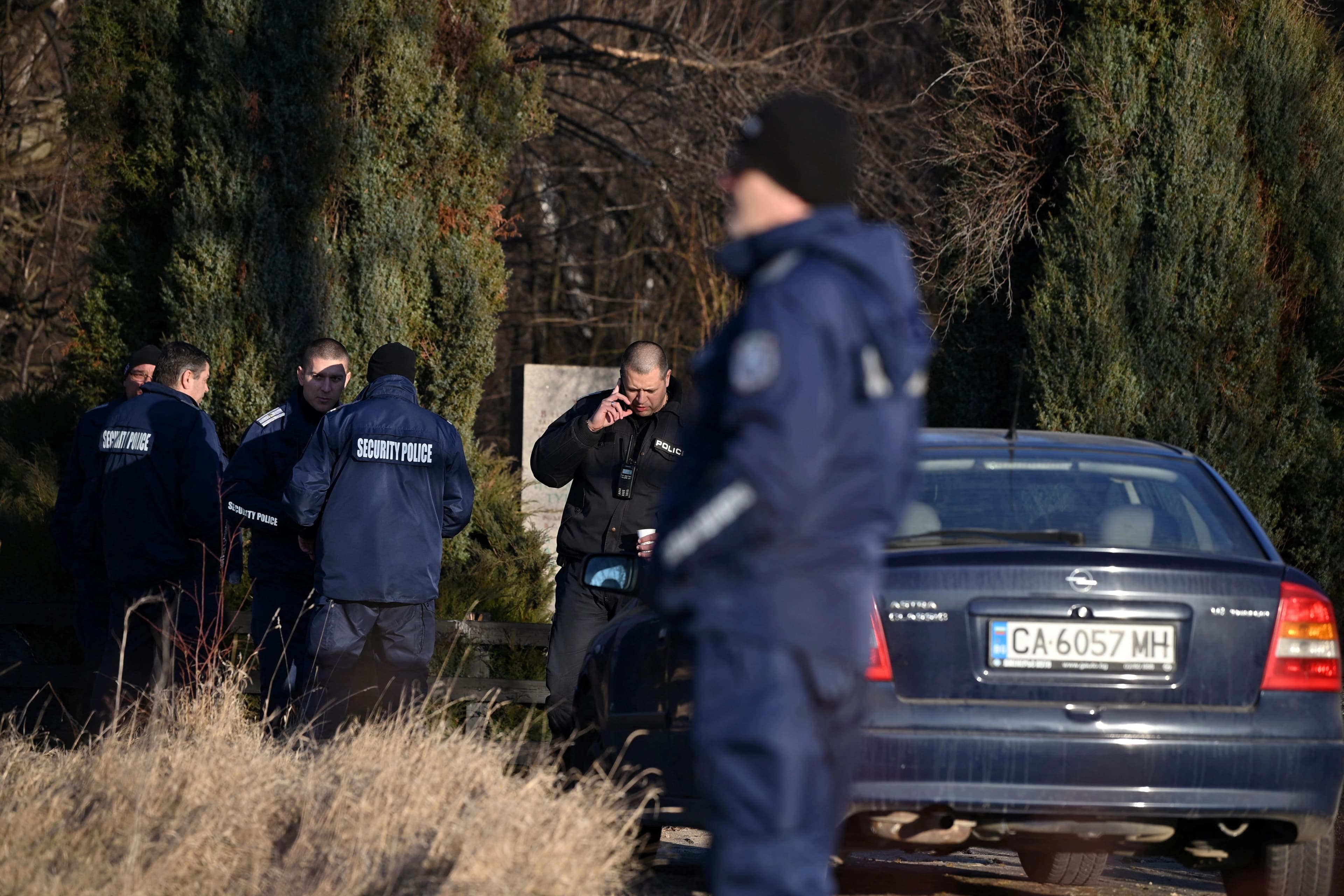 Security officials gather on the outskirts of the village of Lokorsko, some 20 kilometres (12 miles) north-east of Sofia, on February 17, 2023, after the discovery of eighteen dead migrants in the rear of an abandoned truck.