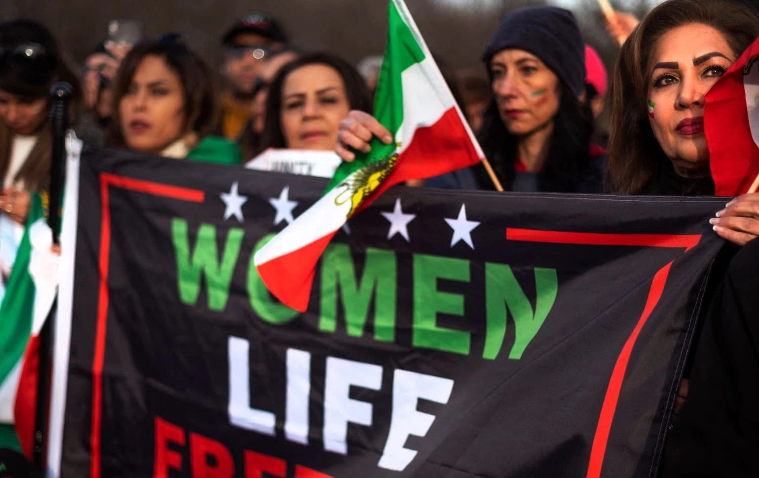 People listen to a speaker during a demonstration to denounce the Iranian government and express support with anti-government protesters in Iran, at the Lincoln Memorial in Washington, DC, on February 11, 2023.