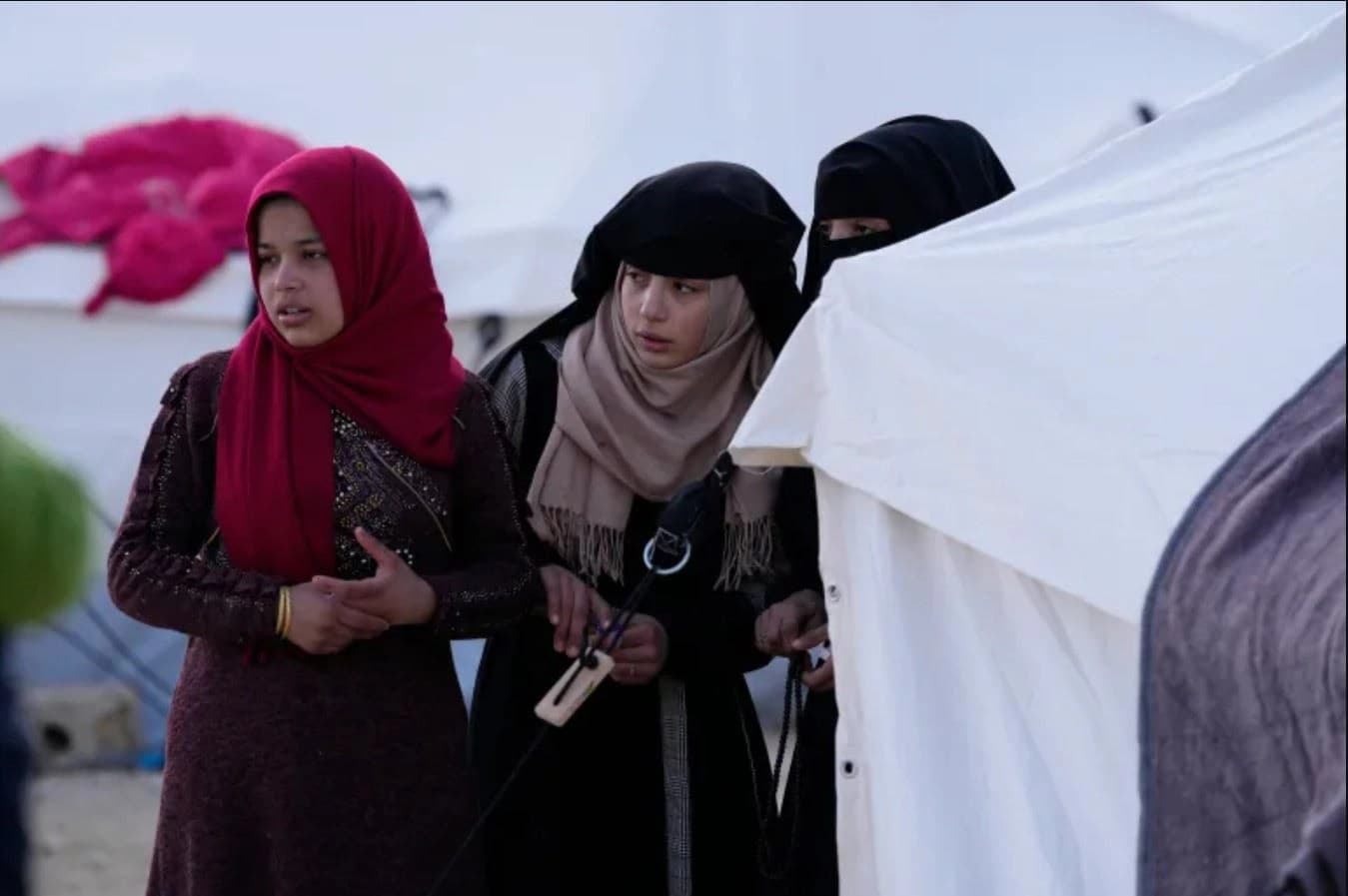 Girls who have lost their homes in February 6's quakes in Turkey look for aid. Photo: AP/file