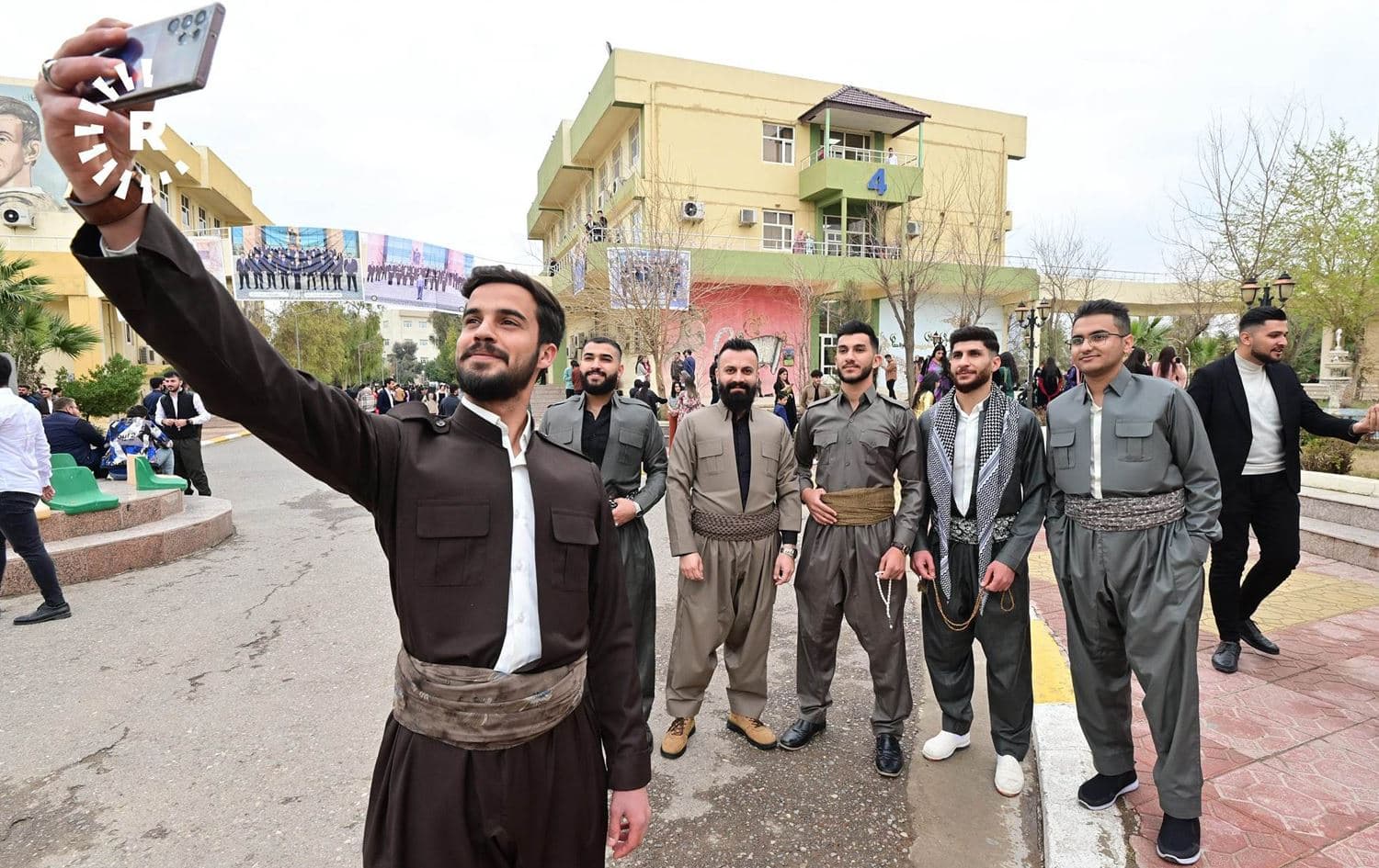 Erbil University students wearing Kurdish clothing gather up for a group photo on March 9, 2023. Photo: Bilind T. Abdullah/Rudaw 