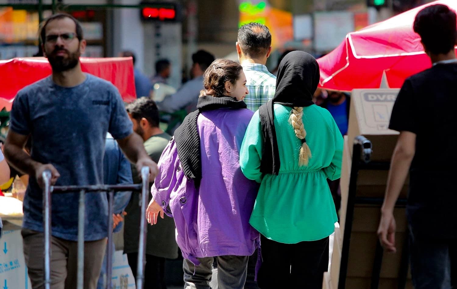 Women walk along a street in Tehran on April 19, 2023. Photo: Atta Kenare/AFP