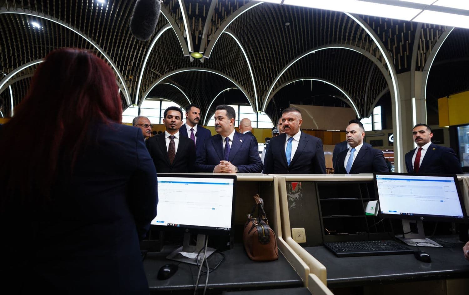 Iraq's Prime Minister Mohammed Shia’ al-Sudani standing by a counter at Baghdad International Airport on April 29, 2023. Photo: PM Sudani's office