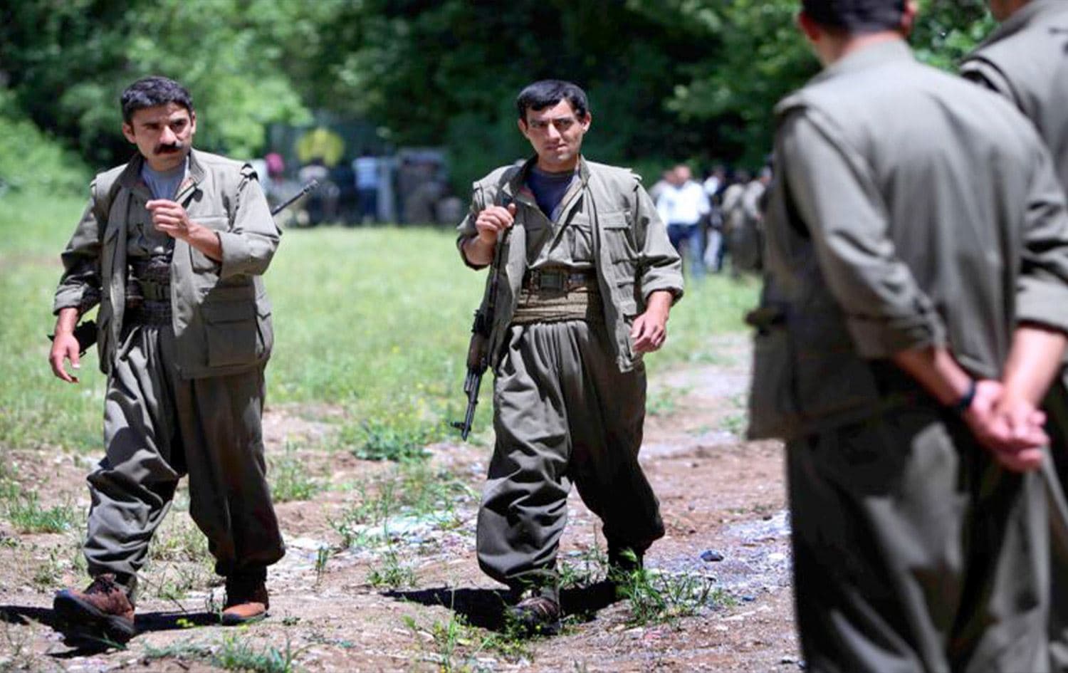 Members of the Free Life Party of Kurdistan (PJAK) - an anti-Iran Kurdish opposition group, carry their weapons as they walk on the grounds of their base deep in the Qandil Mountains in the Kurdistan Region on May 5, 2014. Photo: Safin Hamed/AFP