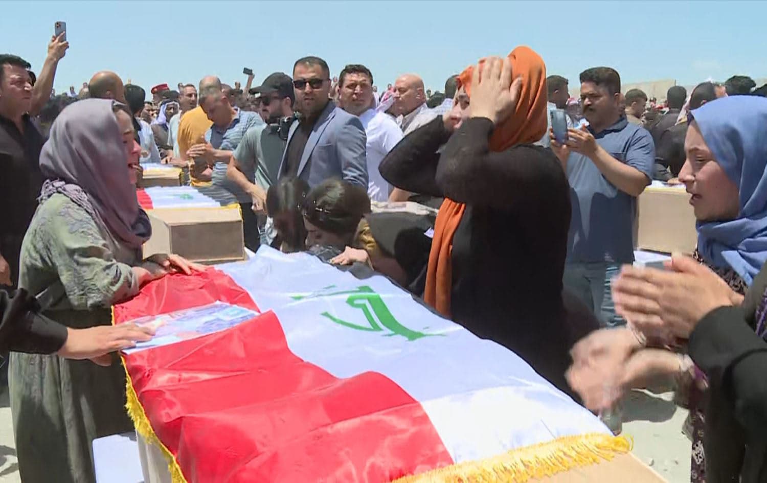 Yazidis in Shingal receive the bodies of their loved ones wo were killed and buried in mass graves by ISIS. Photo: Screengrab/Rudaw