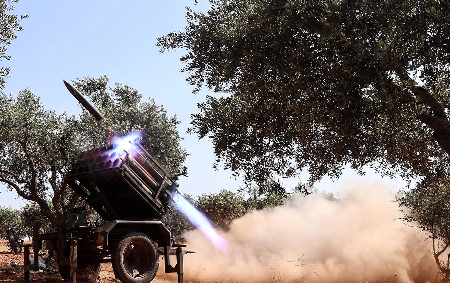 A rocket is fired from a multi-barrel launcher from a position held by the Hay'at Tahrir al-Sham (HTS) jihadist group in Syria's northwestern Idlib province, toward Syrian regime forces, on June 21, 2023. Photo: Omar Haj Kadour/AFP