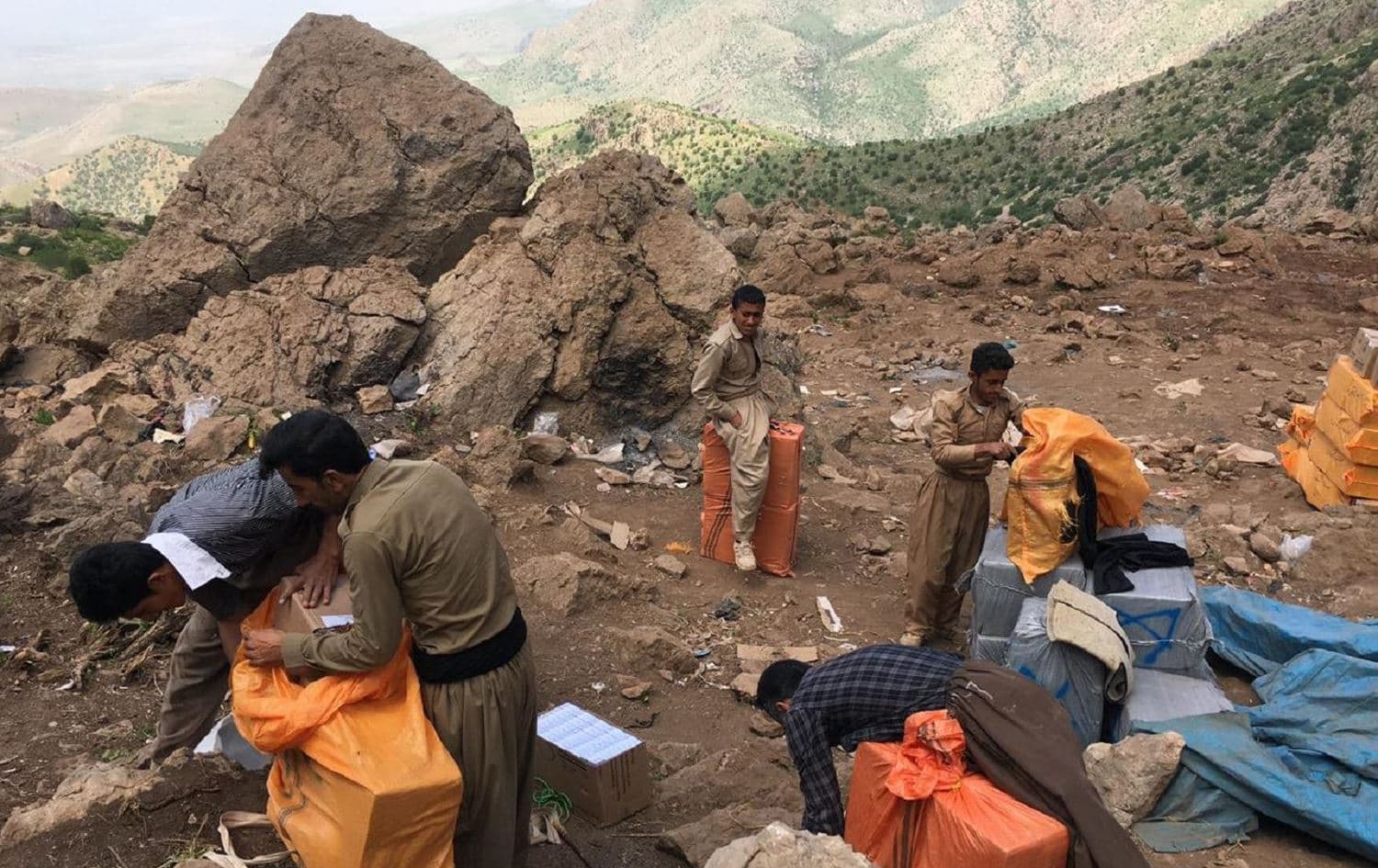 Kolbars adjust their loads high in the Hawraman mountains on the Kurdistan Region-Iran border on May 12, 2017. Photo: Fazel Hawramy/Rudaw