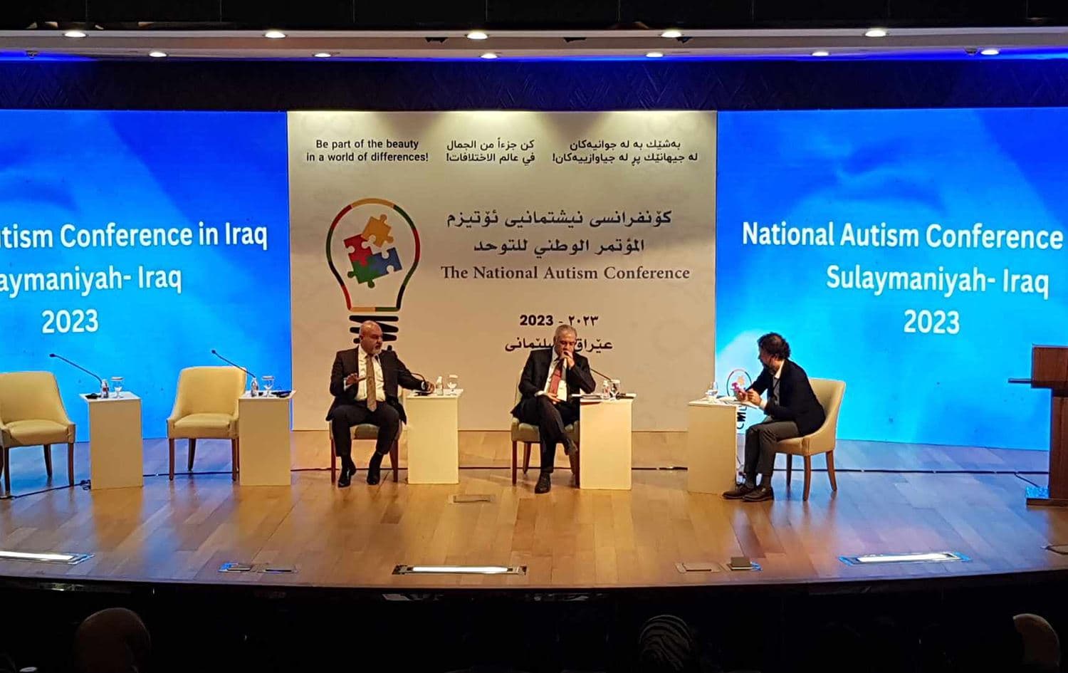 From left, Dr Rahel Faraidun, KRG deputy minister of health, Dr Khamis al-Saad, Iraq's deputy minister of health, and Hemin Khasraw, head of MERG organization for strategic studies speaking during a panel at the National Autism Conference in Sulaimani on September 13, 2023. Photo: Azhi Rasul/Rudaw