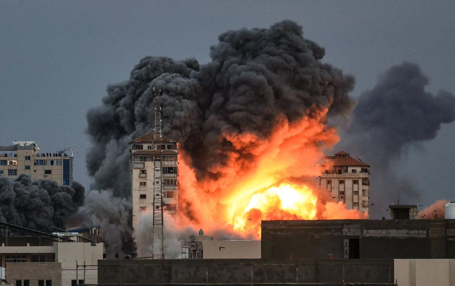 A ball of fire and smoke rises above a building in Gaza City during an Israeli air strike on October 7, 2023. Photo:AFP