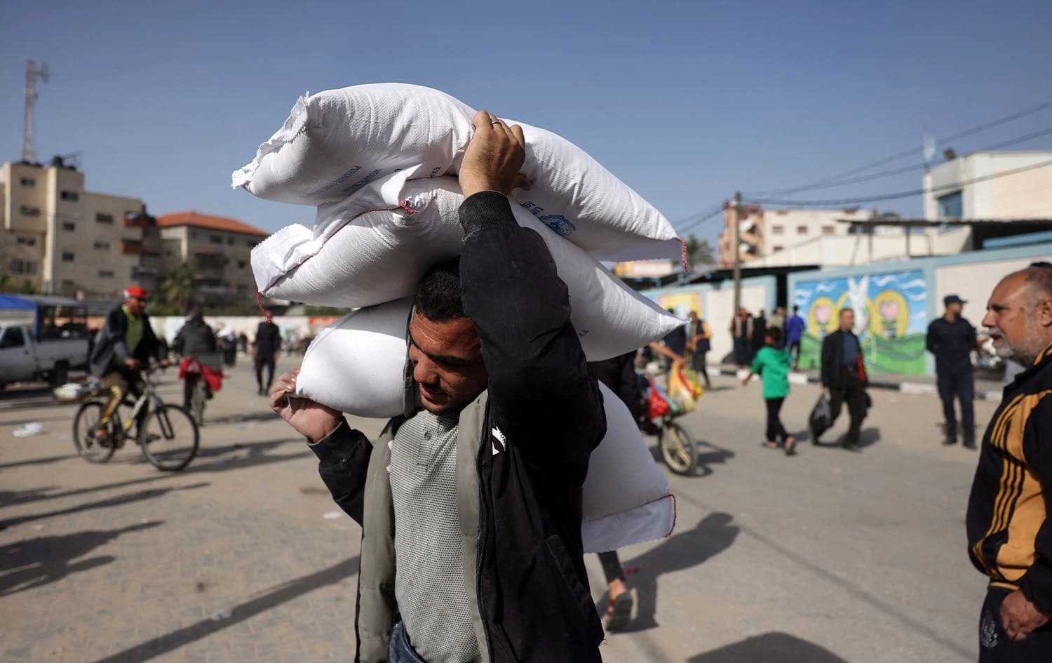 A man carries away bags of humanitarian aid in Rafah in the southern Gaza Strip on November 26, 2023. Photo: Mohammed Abed/AFP