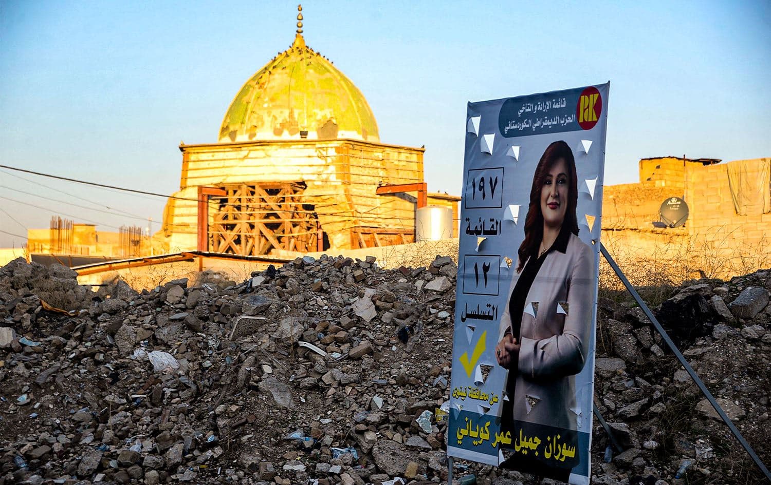 A poster for a candidate running in the 2023 Iraqi municipal elections is displayed outside the ruins of the historic al-Nuri mosque, which was heavily damaged during the battles 2017 with the Islamic State (IS) group fighters, in the old town of Iraq's northern city of Mosul on December 17, 2023. Photo: Zaid al-Obeidi/AFP