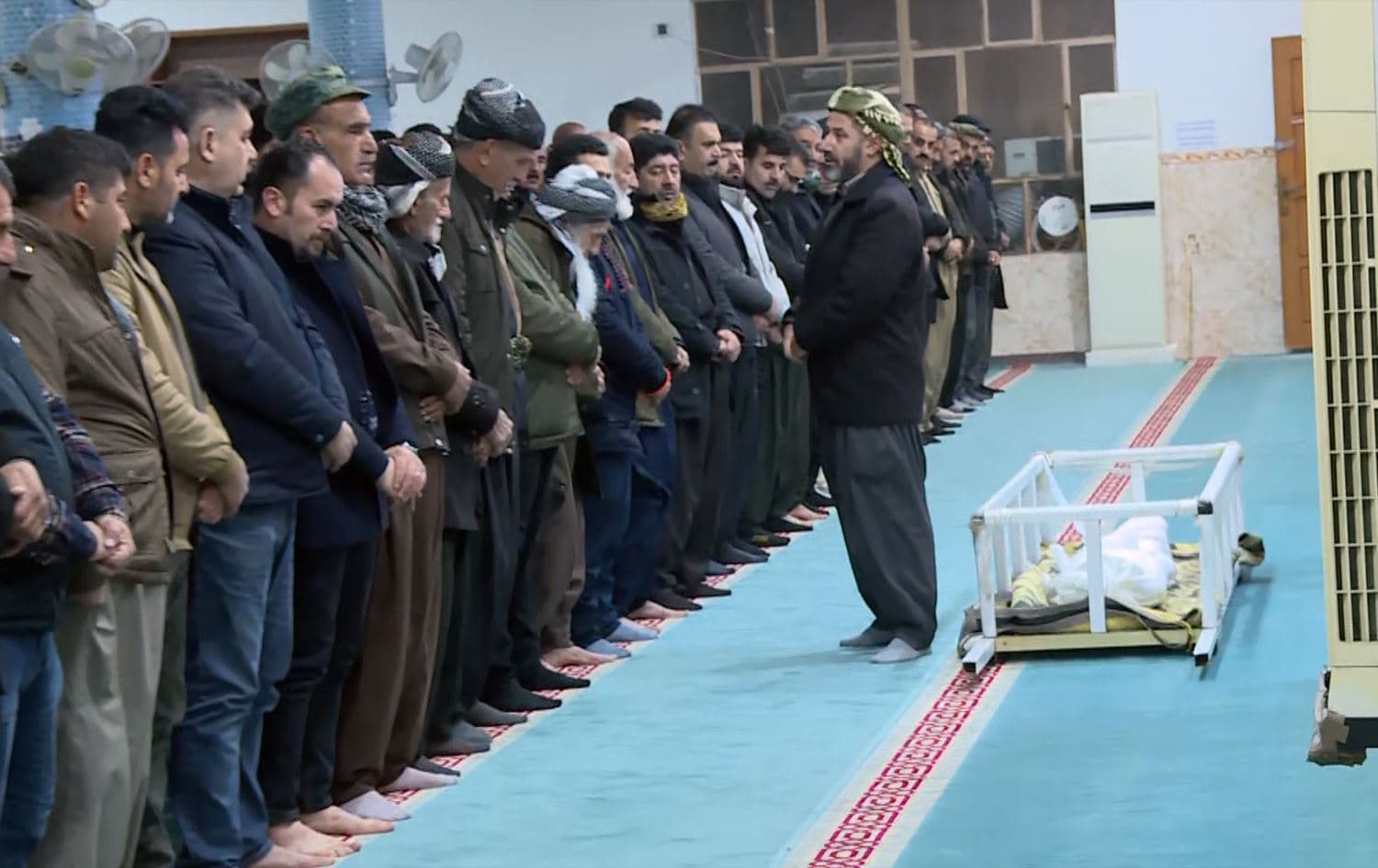 Mourners prepare to perform funeral prayers for 12-year-old Lawand Karwan in Sulaimani’s Chaqalawa village on February 4, 2024. Photo: Rudaw/screengrab