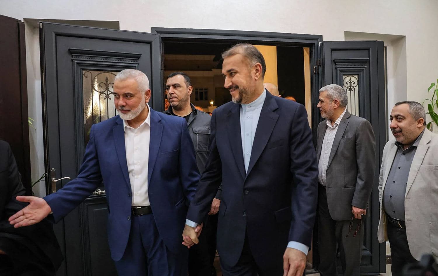 This handout picture provided by the Iranian foreign ministry on Dec. 20, 2023, shows Qatar-based Hamas leader Ismail Haniyeh (L) welcoming Iranian Foreign Minister Hossein Amir Abdollahian in Doha. Photo: Iranian foreign ministry/AFP