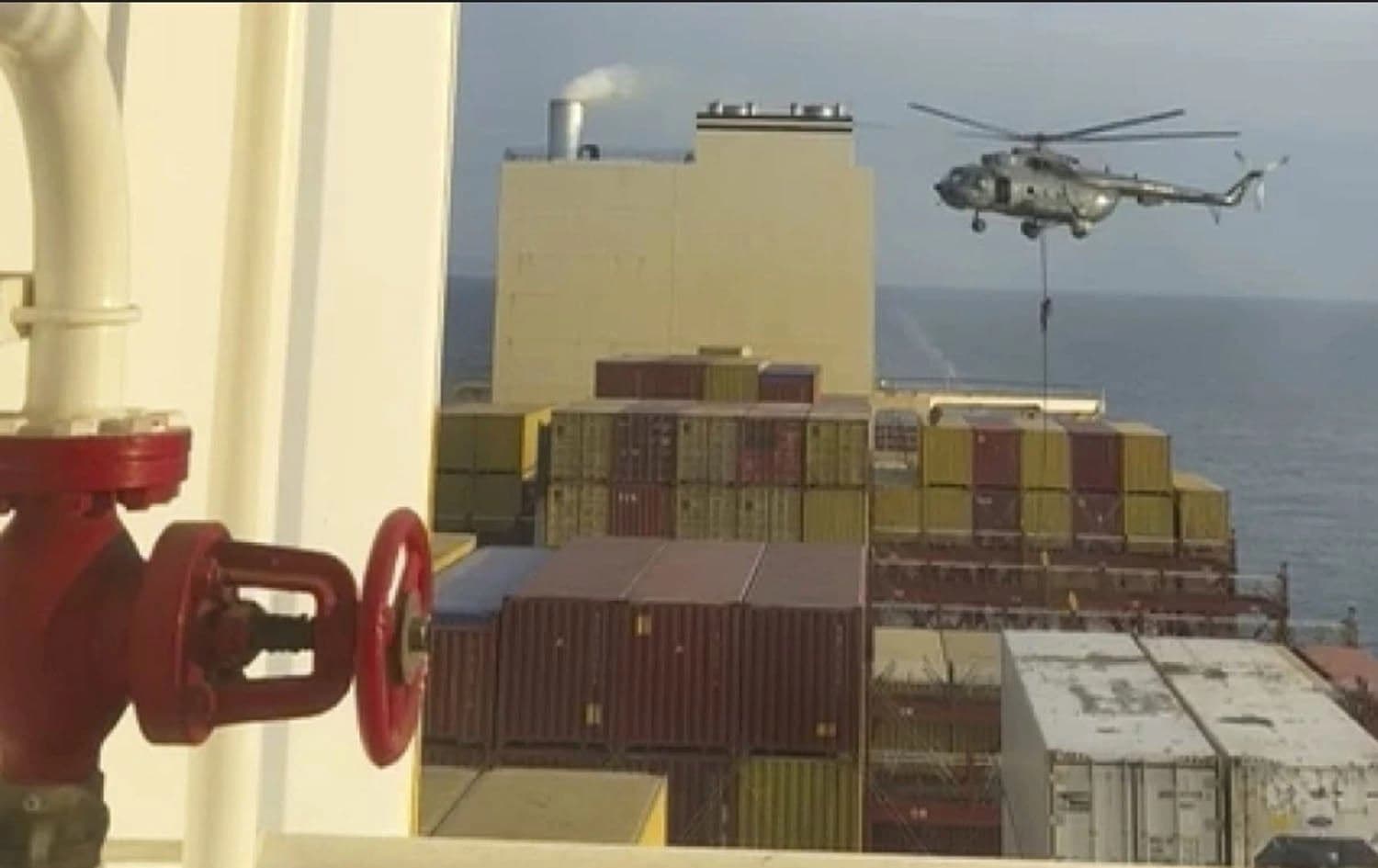 This image made from a video provided to The Associated Press by a Mideast defense official shows a helicopter raid targeting a vessel near the Strait of Hormuz on Saturday, April 13, 2024. 