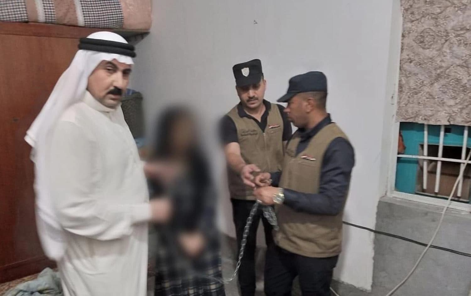کاتی رزگارکردنی ژنەکە لەلایەن پۆلیسەوە، کە وەکو لە وێنەکە دەردەکەوێت، زنجیر کراوە
