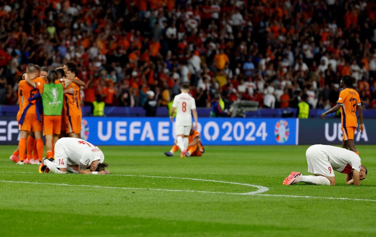 Turkey's players react as Netherlands players celebrate after the UEFA Euro 2024 quarter-final football match between the Netherlands and Turkey at the Olympiastadion in Berlin on July 6, 2024. Photo: Odd Andersen/AFP