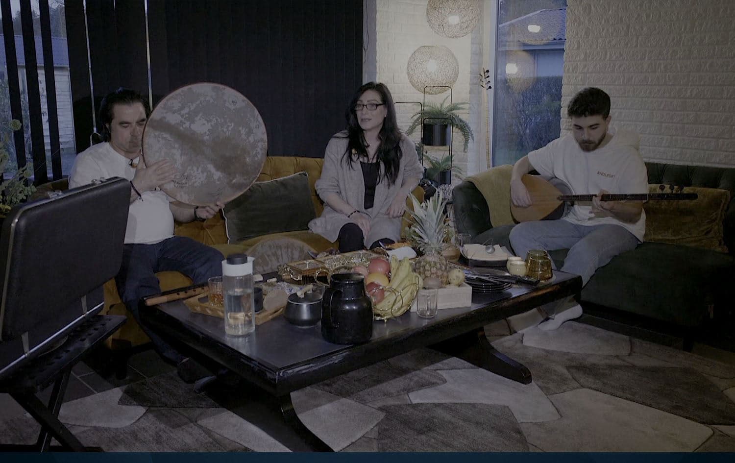 From left: Waleed Hamoto, Malak Mukhtar, and their son Ali Sher performing in their home on July 12, 2024. Photo: Rudaw