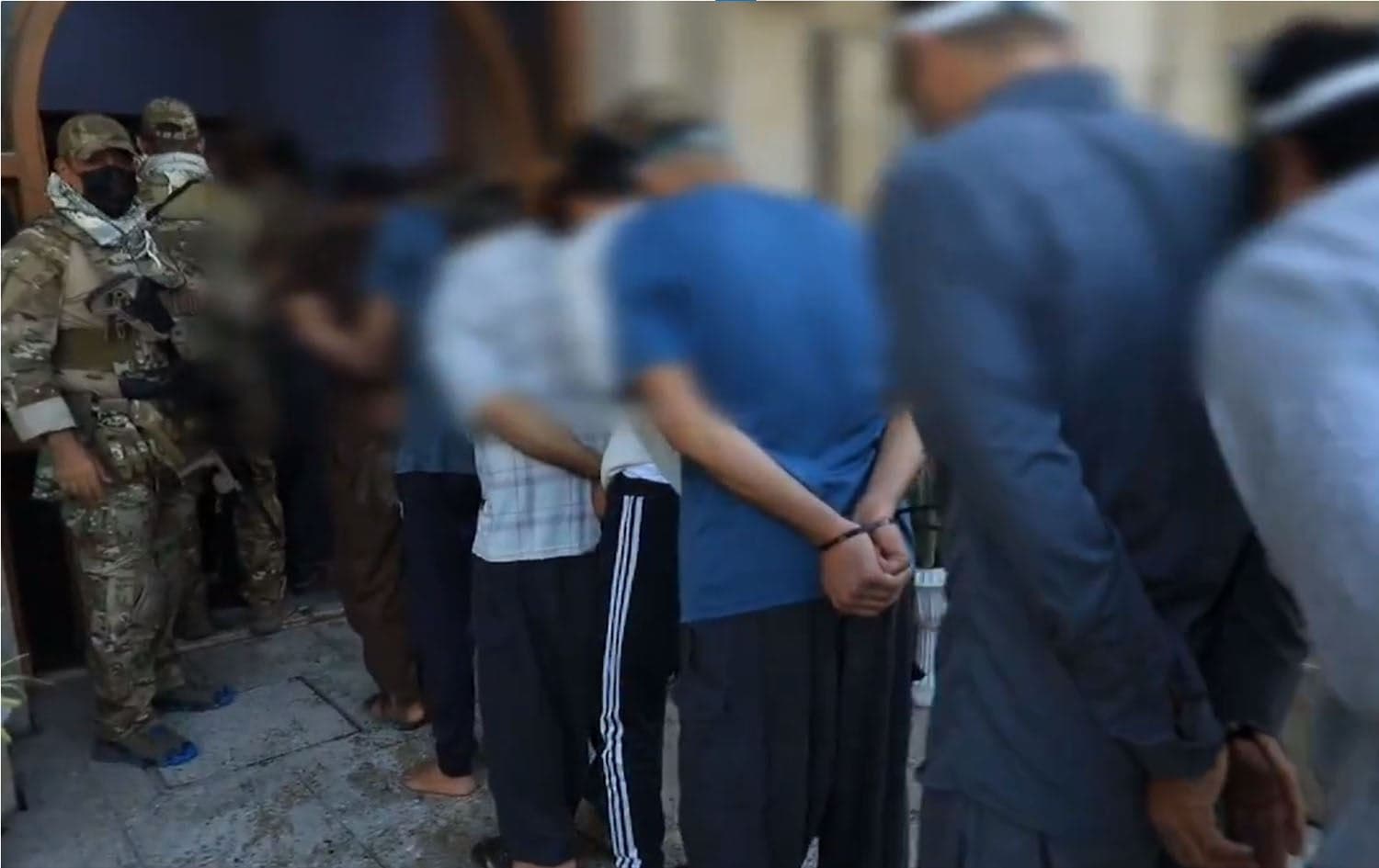 The picture shows the suspected ISIS members handcuffed by Iraqi and Kurdish security forces. Photo: Screengrab/Security Media Cell