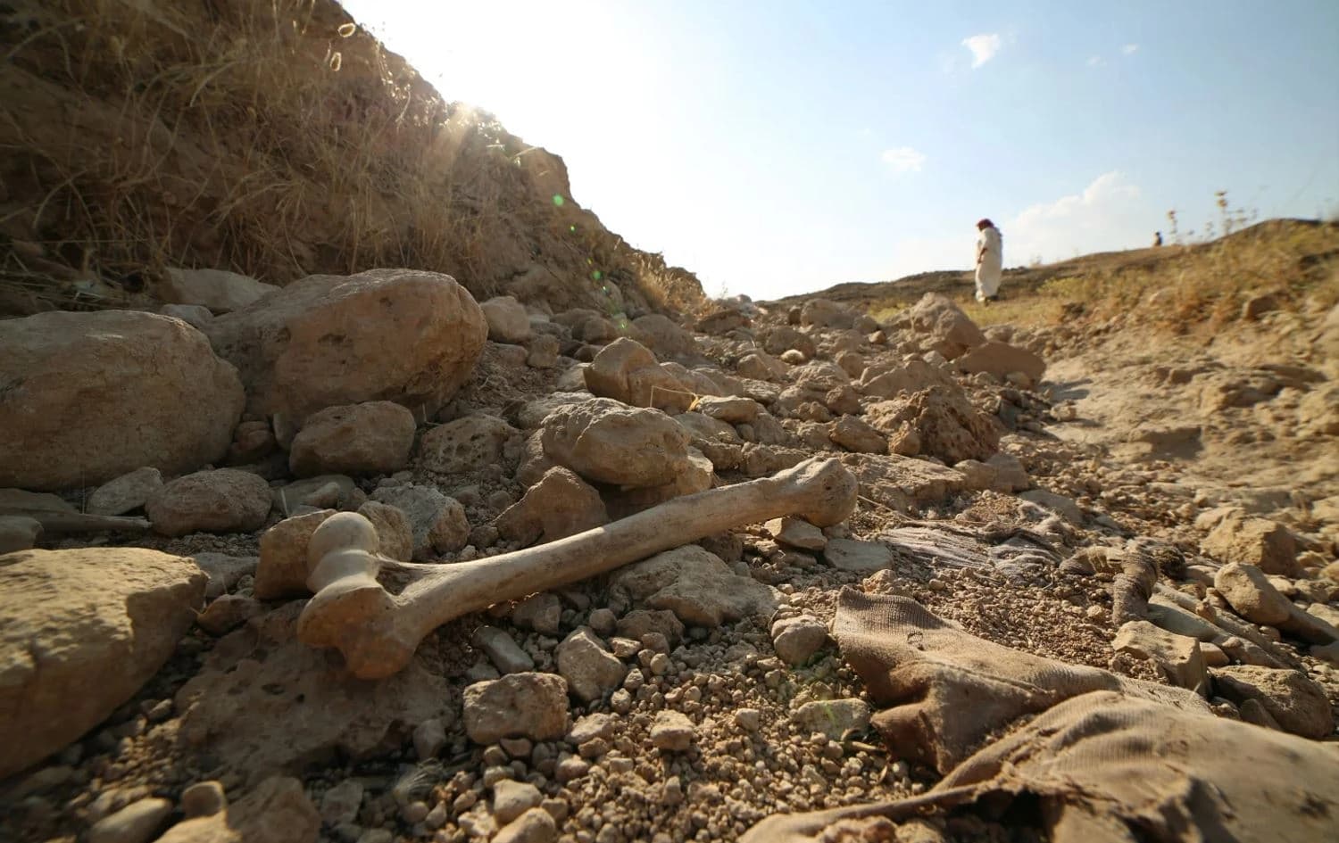 People visit a mass grave for ISIS victims in Mosul on July 1, 2020. Photo: Farid Abdulwahed/AP