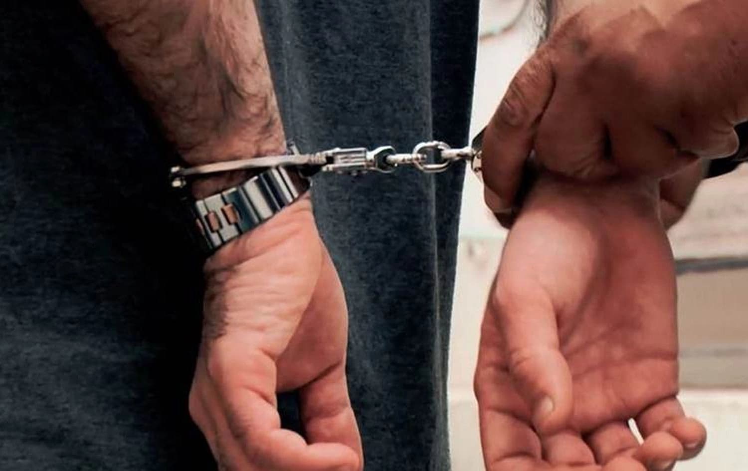 Man being handcuffed. File photo: Rudaw