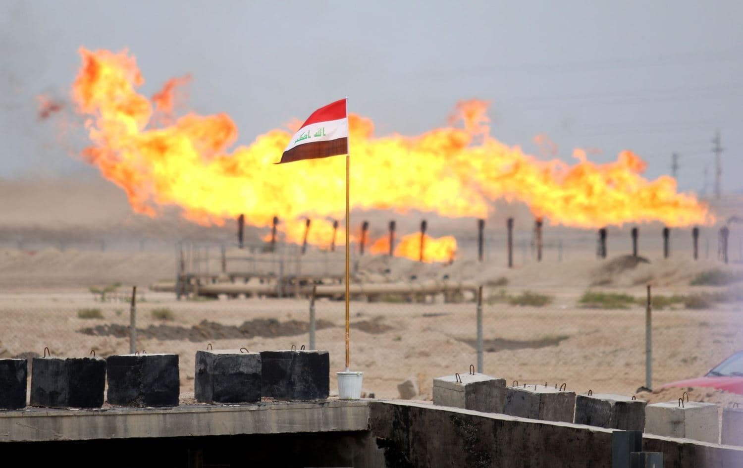 An Iraqi flag close to an oil refinery near Basra in southern Iraq. File photo: AFP