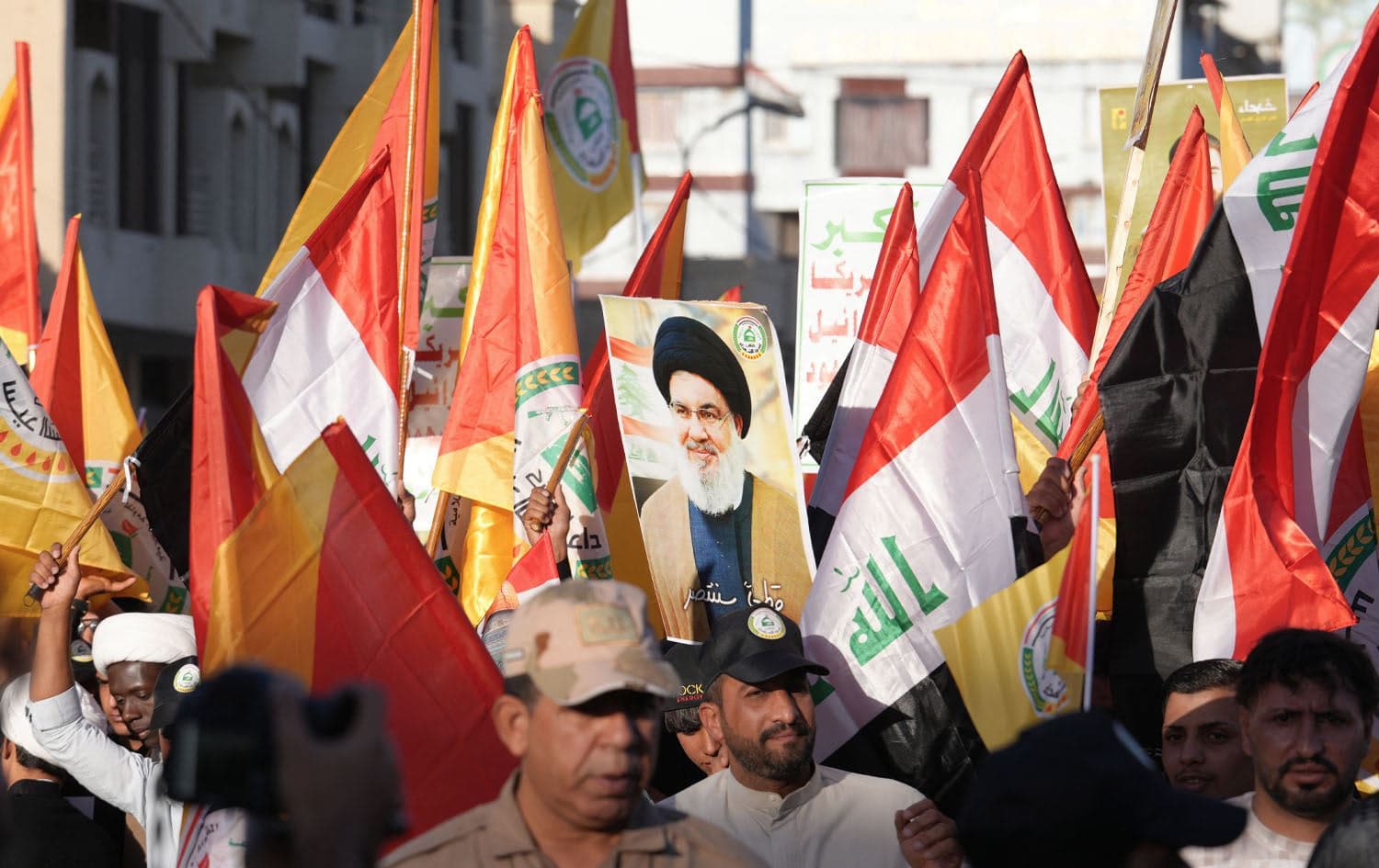 Supporters of Iraq's Hezbollah Brigades wave flags as they demonstrate to show solidarity with Lebanon's Hezbollah movement in the central holy shrine city of Najaf on September 27, 2024. Photo: Qassem al-KAABI / AFP