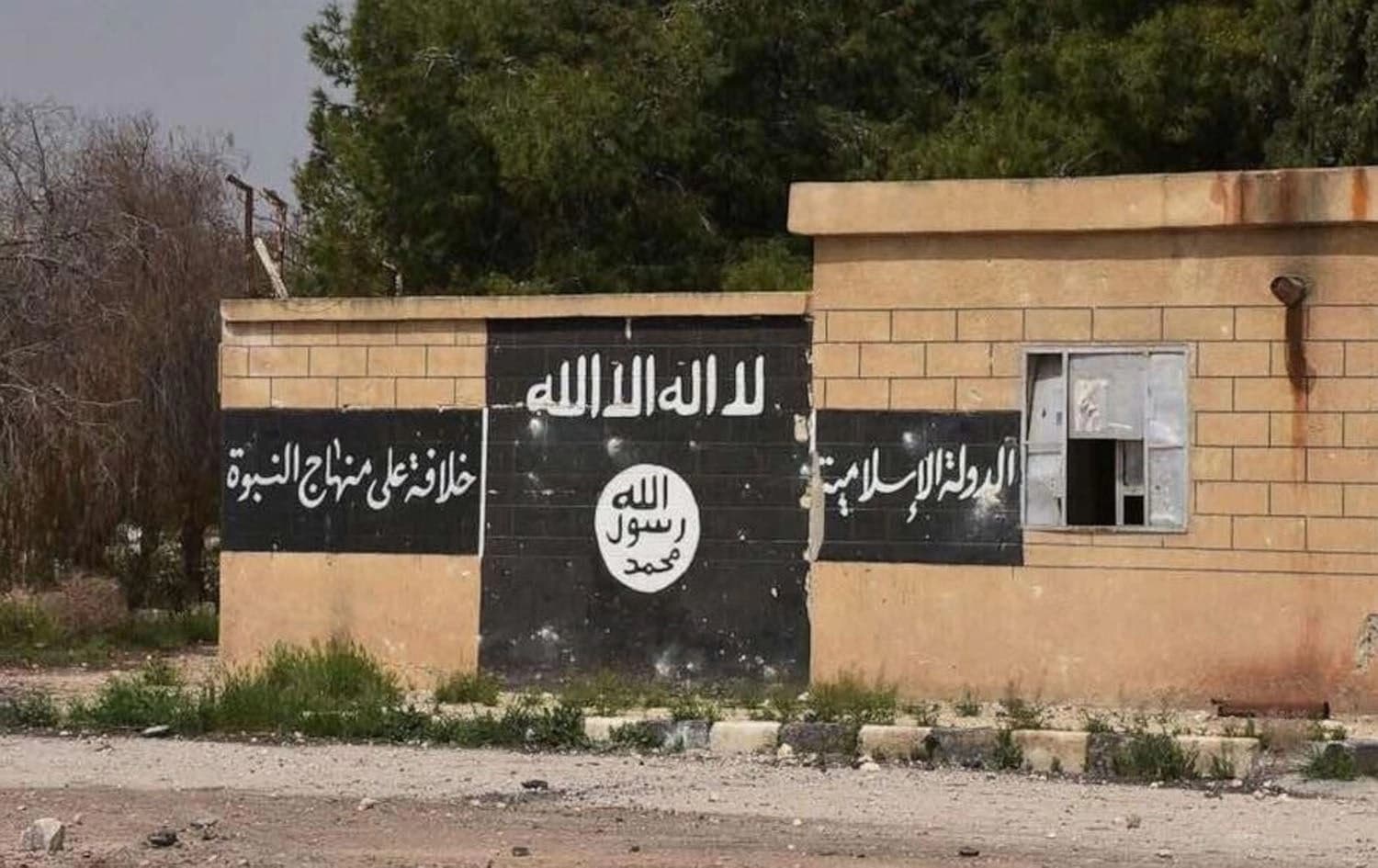 An ISIL flag painted on the wall in Deir Hafer, Aleppo Governorate in Syria. File photo: AP
