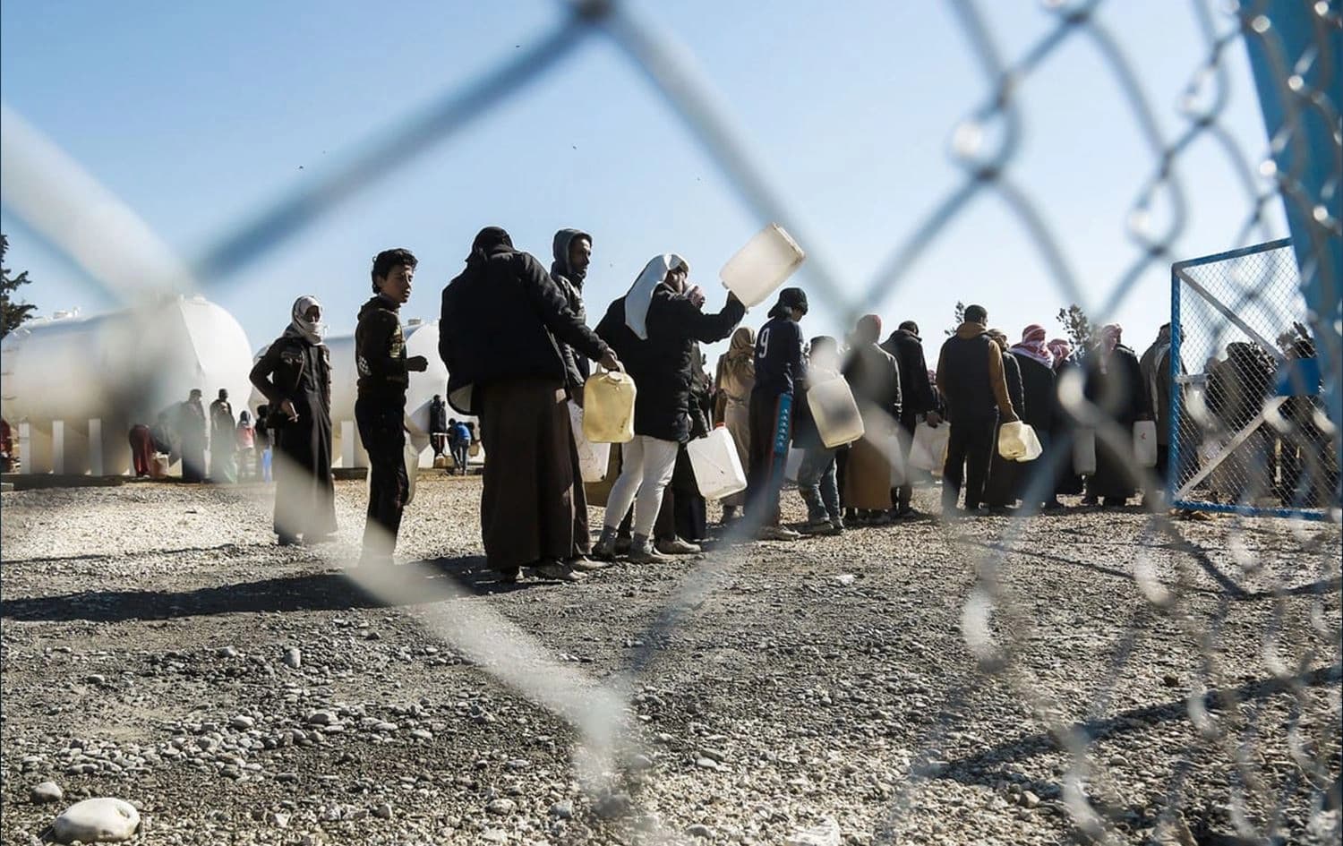 Refugees line up for water at al-Hol camp in Syria on 29 January 2017. File photo: Delil Souleiman/AFP