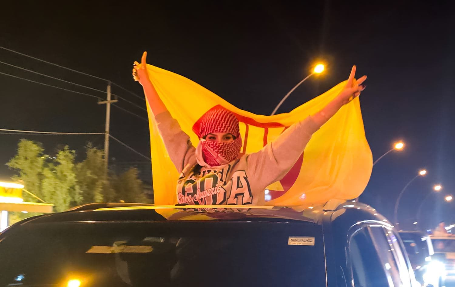 A Kurdistan Democratic Party (KDP) supporter gestures during celebrations following the Kurdistan Region's parliamentary elections in Erbil on October 20, 2024. Photo: Bilind T. Abdullah/Rudaw