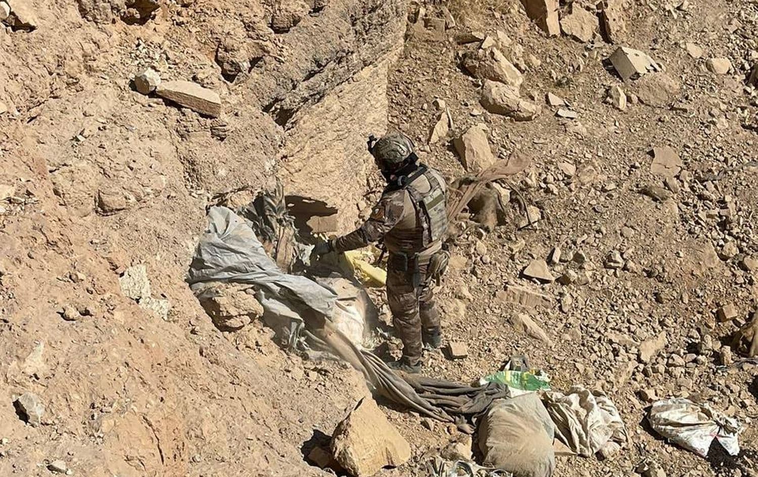 A member of Iraq’s security forces inspects an Islamic State (ISIS) hideout in the desert of Anbar’s northern Rutba district in a handout photo released on October 24, 2024: Photo: Joint Operations Command