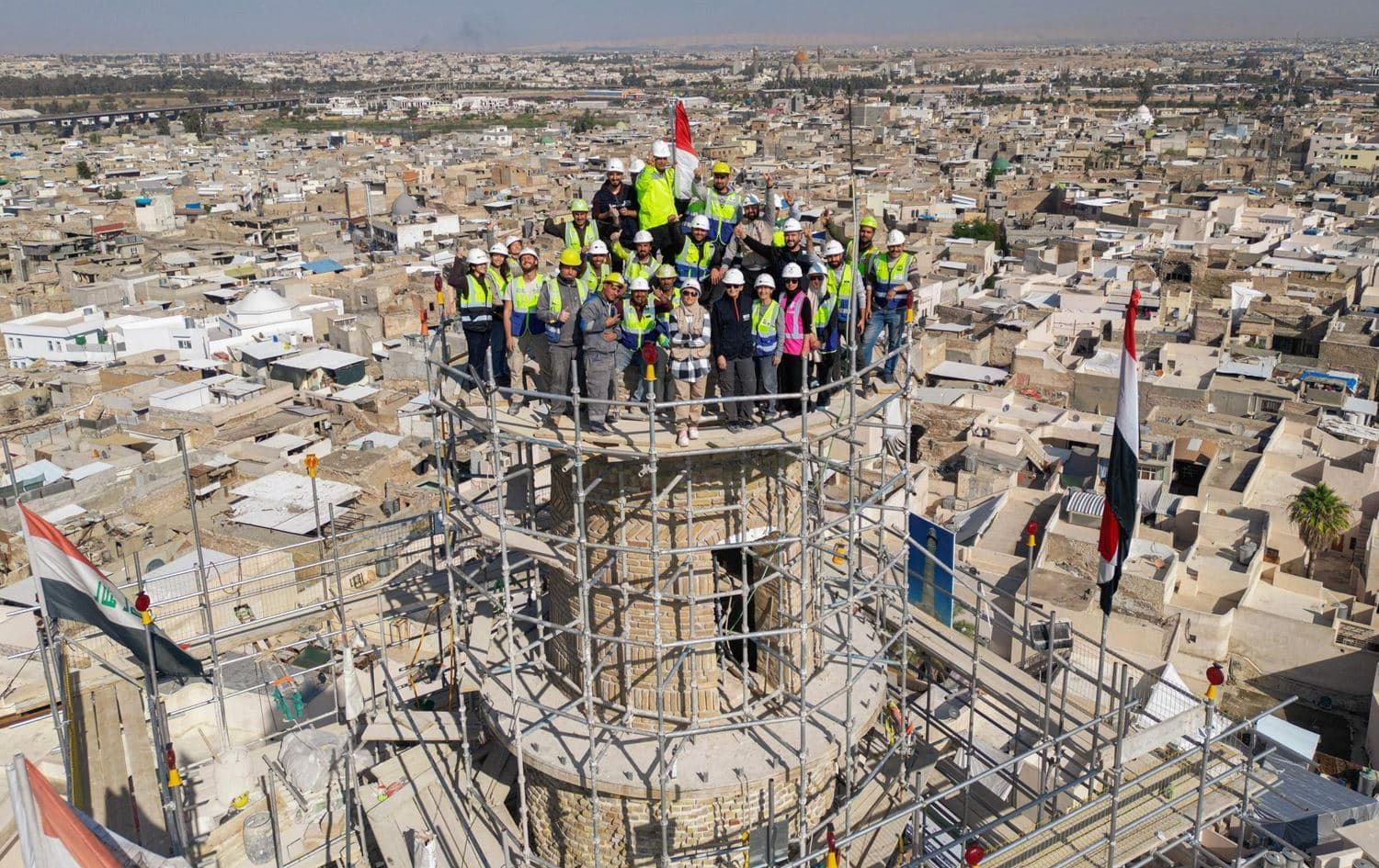 A UNESCO reconstruction team stands atop scaffolding around Mosul’s al-Hadba minaret. Photo: UNESCO/Abdullah Rashid.