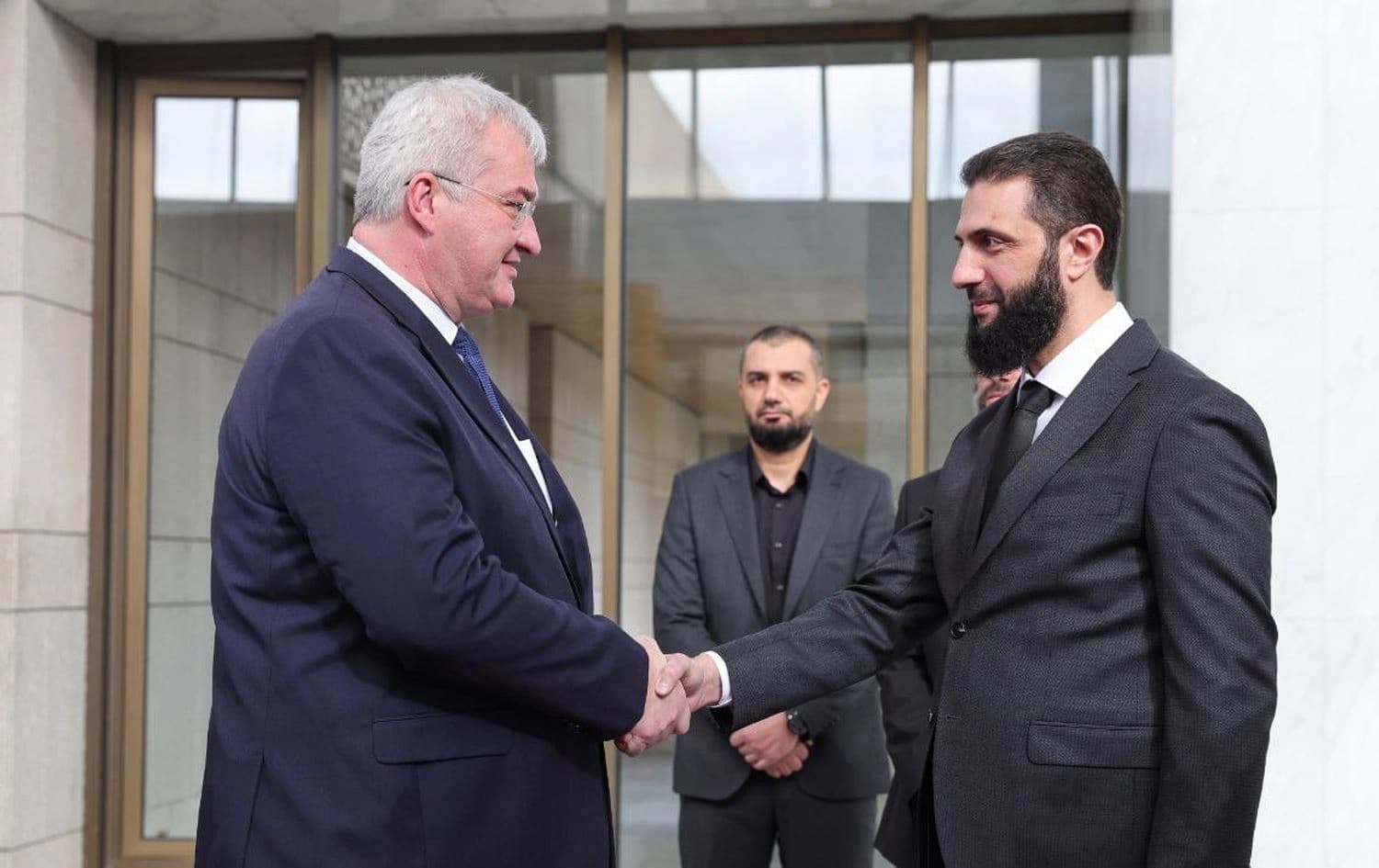 Ukrainian Foreign Minister Andrii Sybiha (left) and Syrian de facto leader Ahmad al-Sharaa (right) shaking hands in Damascus, Syria on December 30, 2024. Photo: SANA