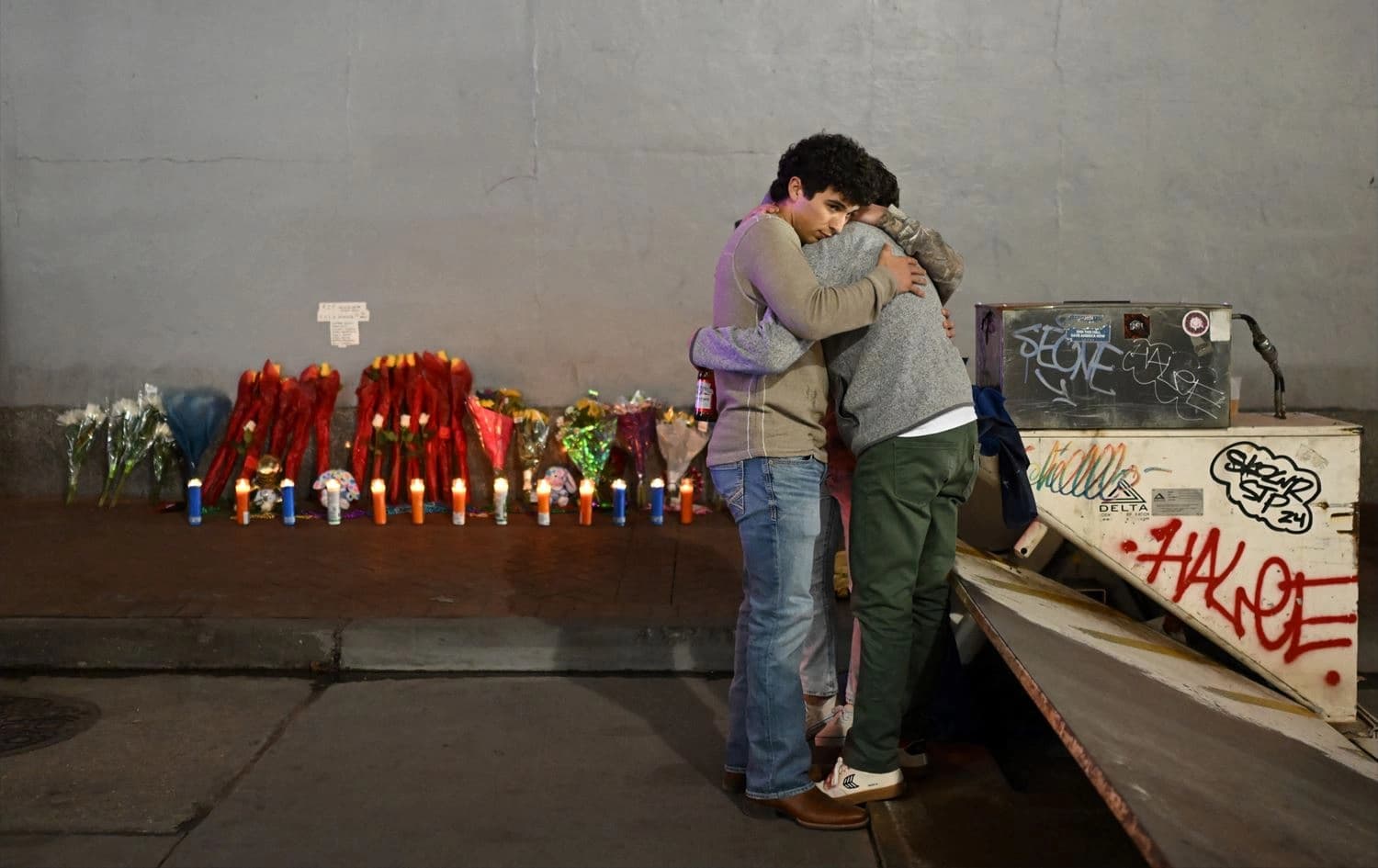 People react at a memorial set up on January 2, 2025 in New Orleans, Louisiana, the day after an attack by a man driving a truck down Bourbon street in the French Quarter. Photo: Andrew Caballero-Reynolds/AFP