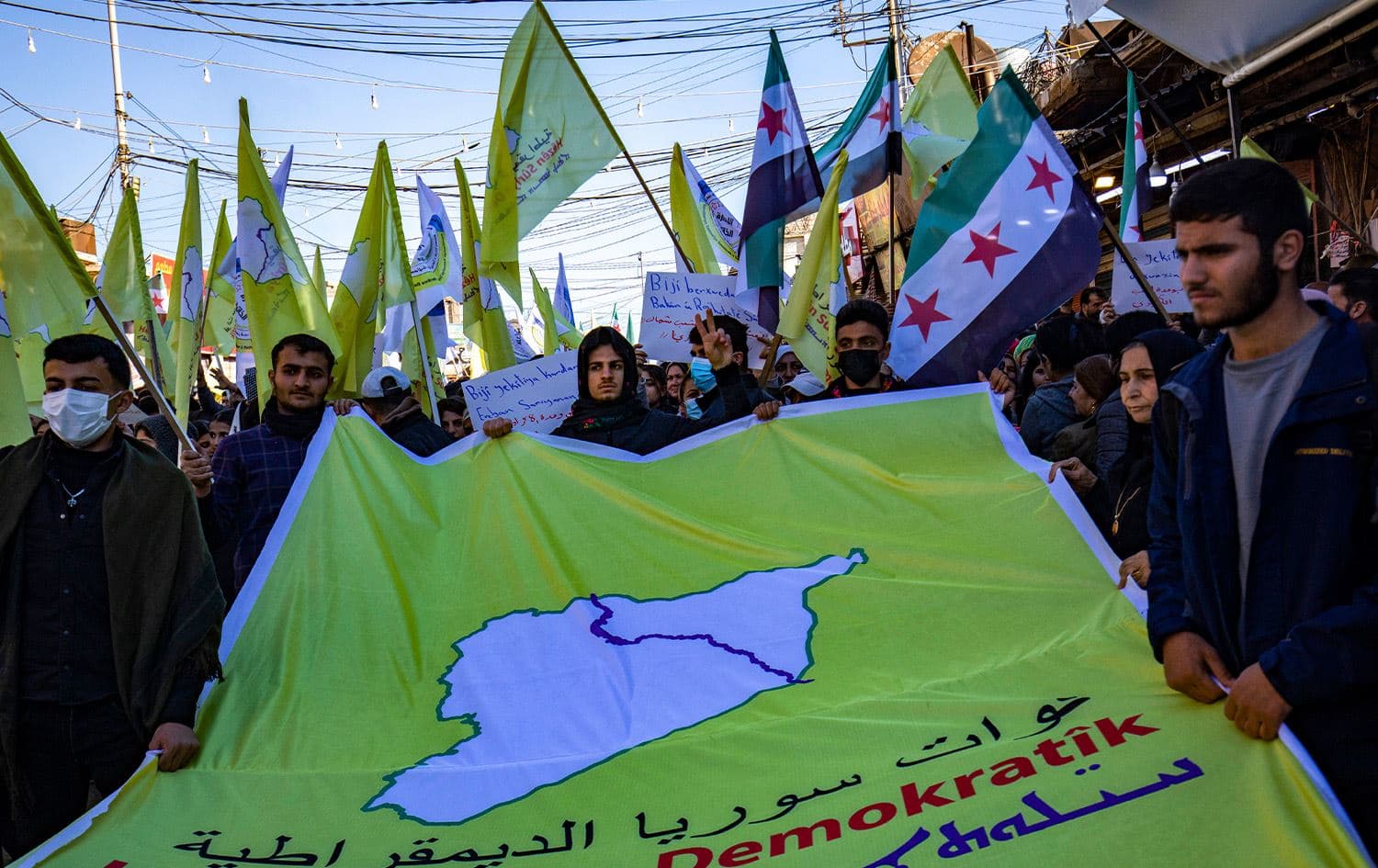 Syrian Kurds wave independence-era flags during a demonstration in support of the US-backed, Kurdish-led Syrian Democratic Forces in the northeastern city of Qamishli, on December 19, 2024. Photo: Delil Souleiman/AFP