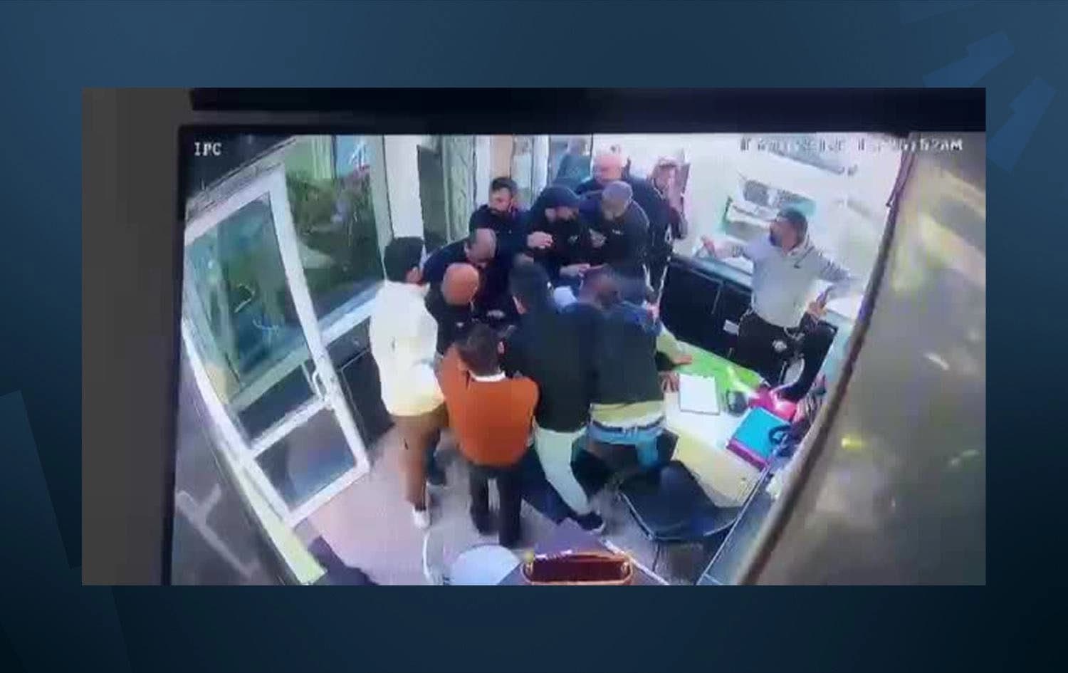 University guards and police officers arresting the alleged shooter in Baghdad’s al-Esraa University. Photo: Submitted