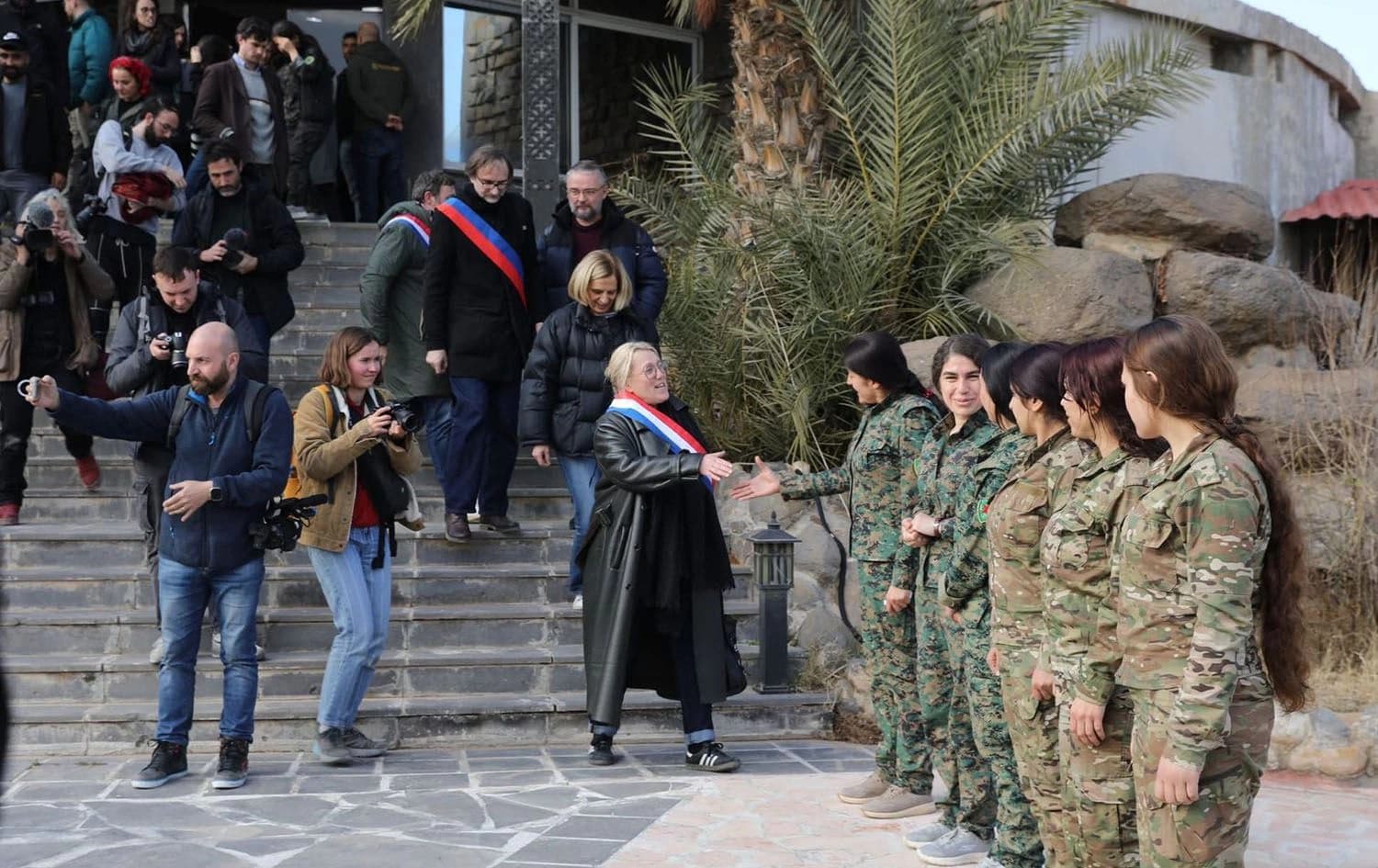 European delegates shake hands with YPJ members in Rojava on January 25, 2025. Photo: YPJ
