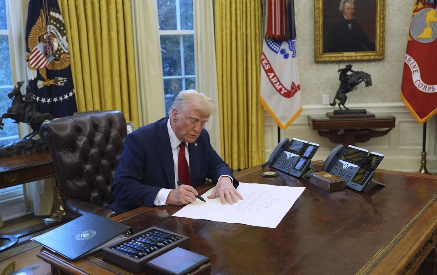 US President Donald Trump signs executive orders in the White House on January 30, 2025. Photo: AP/Evan Vucci