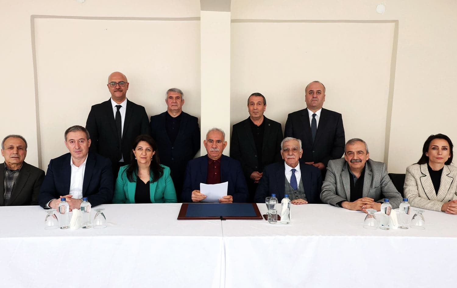 Image shared by DEM Party on February 27, 2025 shows Ocalan holding papers in his hands and sitting alongside the delegates who visited him at Imrali prison earlier in the day. 