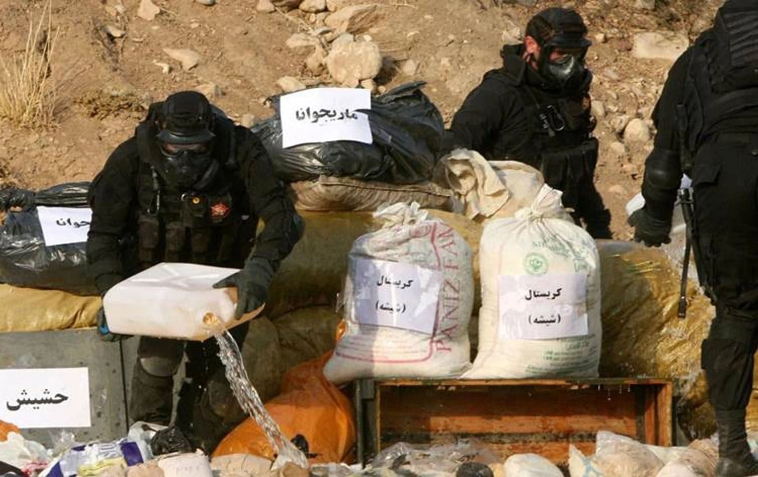 Members of the Asayish forces stand next to a pile of seized drugs about to be burned in Erbil. File Photo: AFP