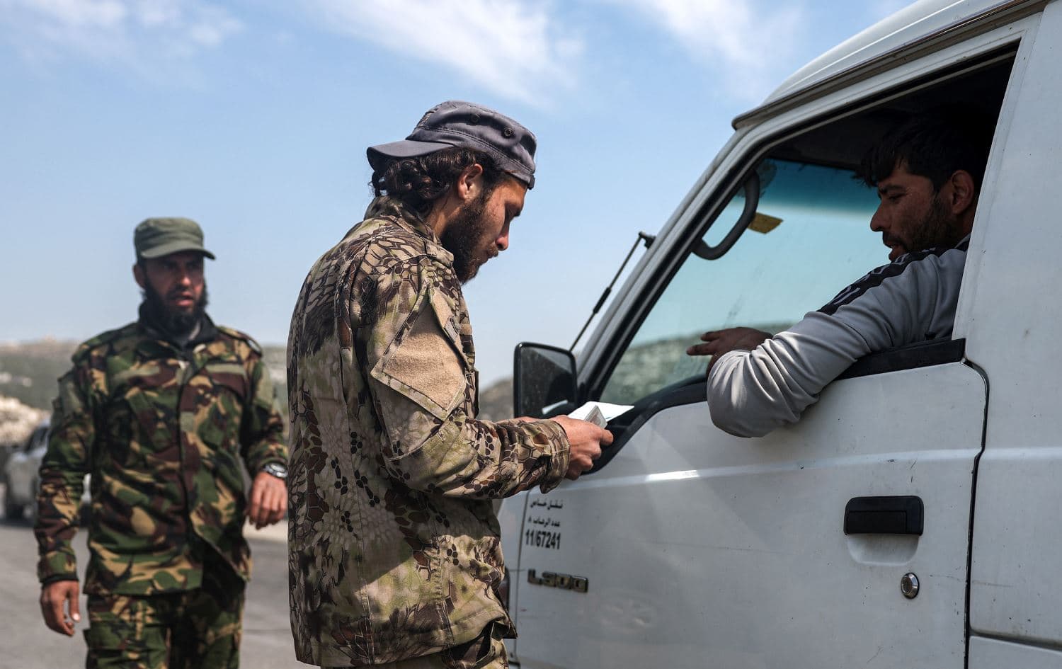 Syrian interim government security forces stopping a vehicle for inspection at a checkpoint in Syria's western city of Latakia on March 9, 2025. Photo: Omar Haj Kadour/AFP